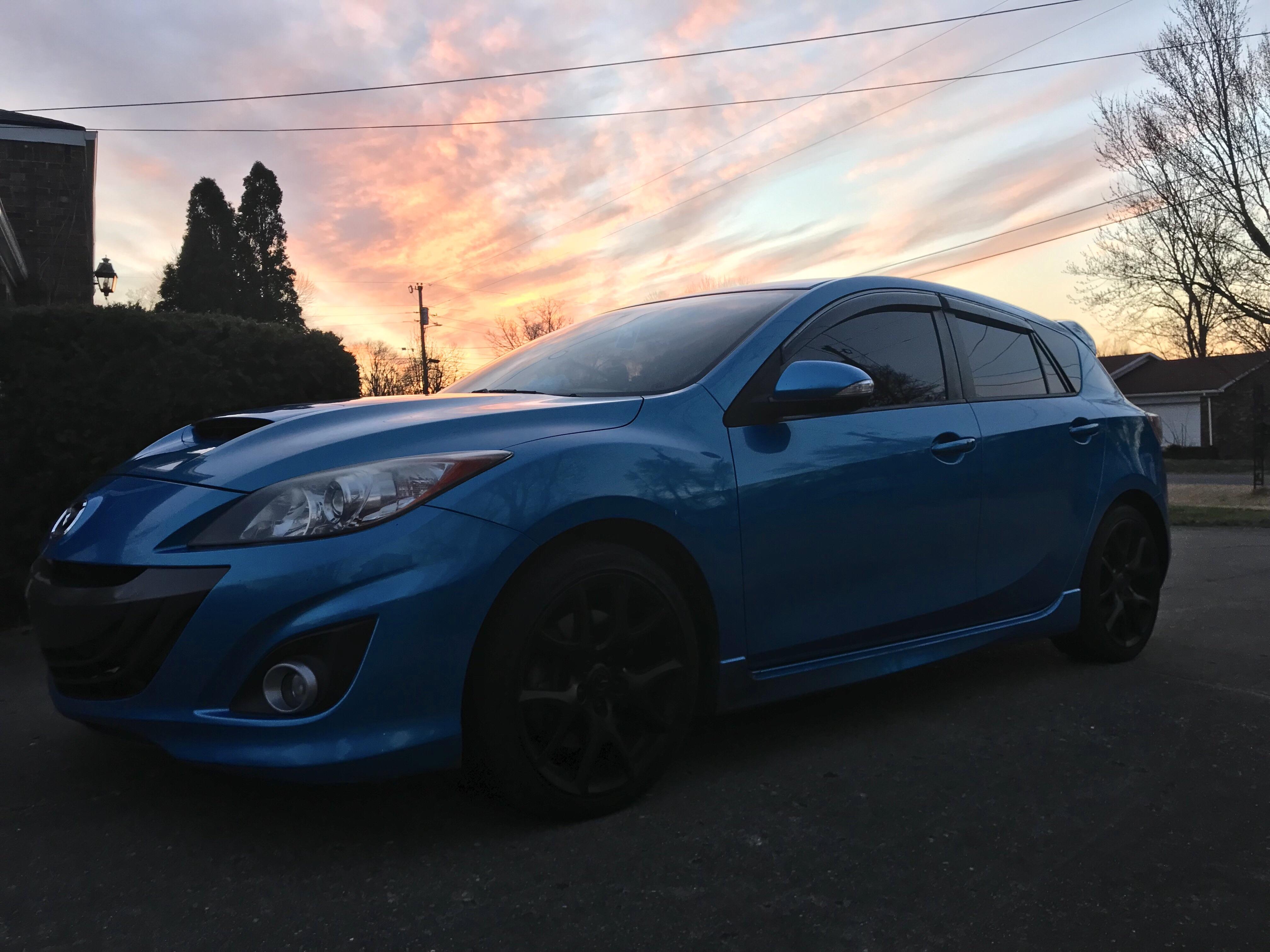 The sun setting on a plump Blueberry. r/mazda