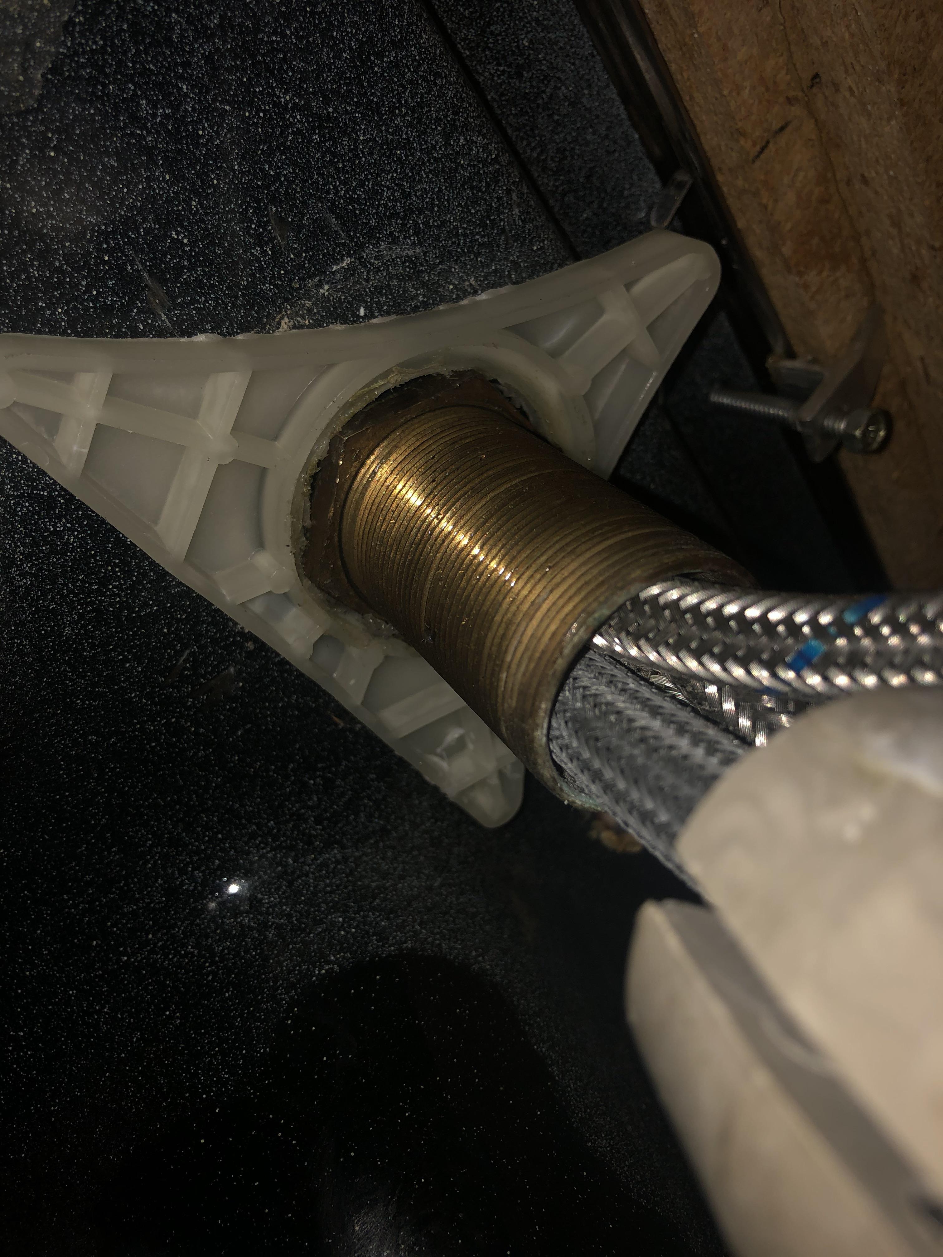 Plastic triangle bracket on nut won’t budge under kitchen faucet. How