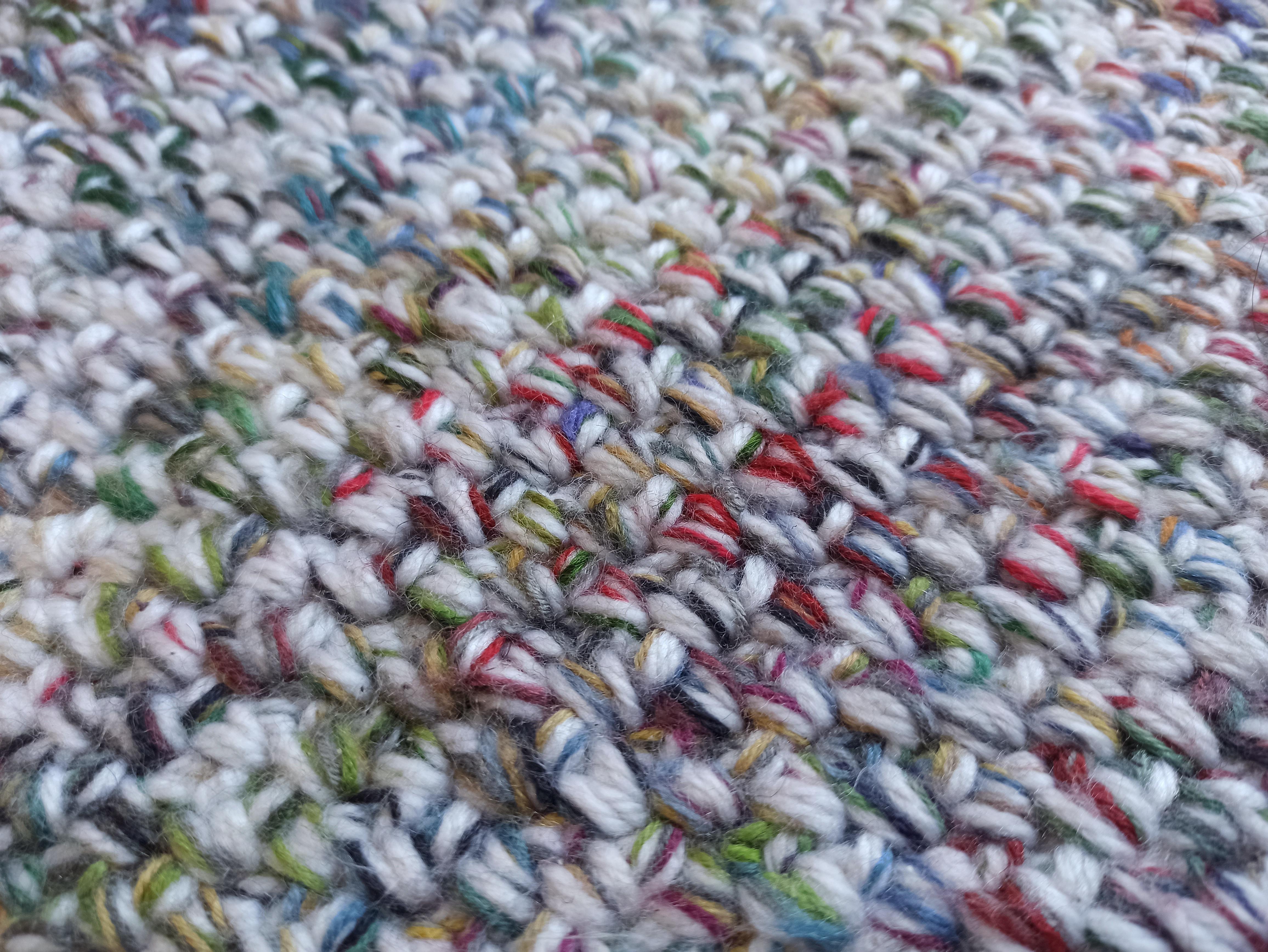 Crochet rug made with reclaimed yarns and leftover bits and pieces r