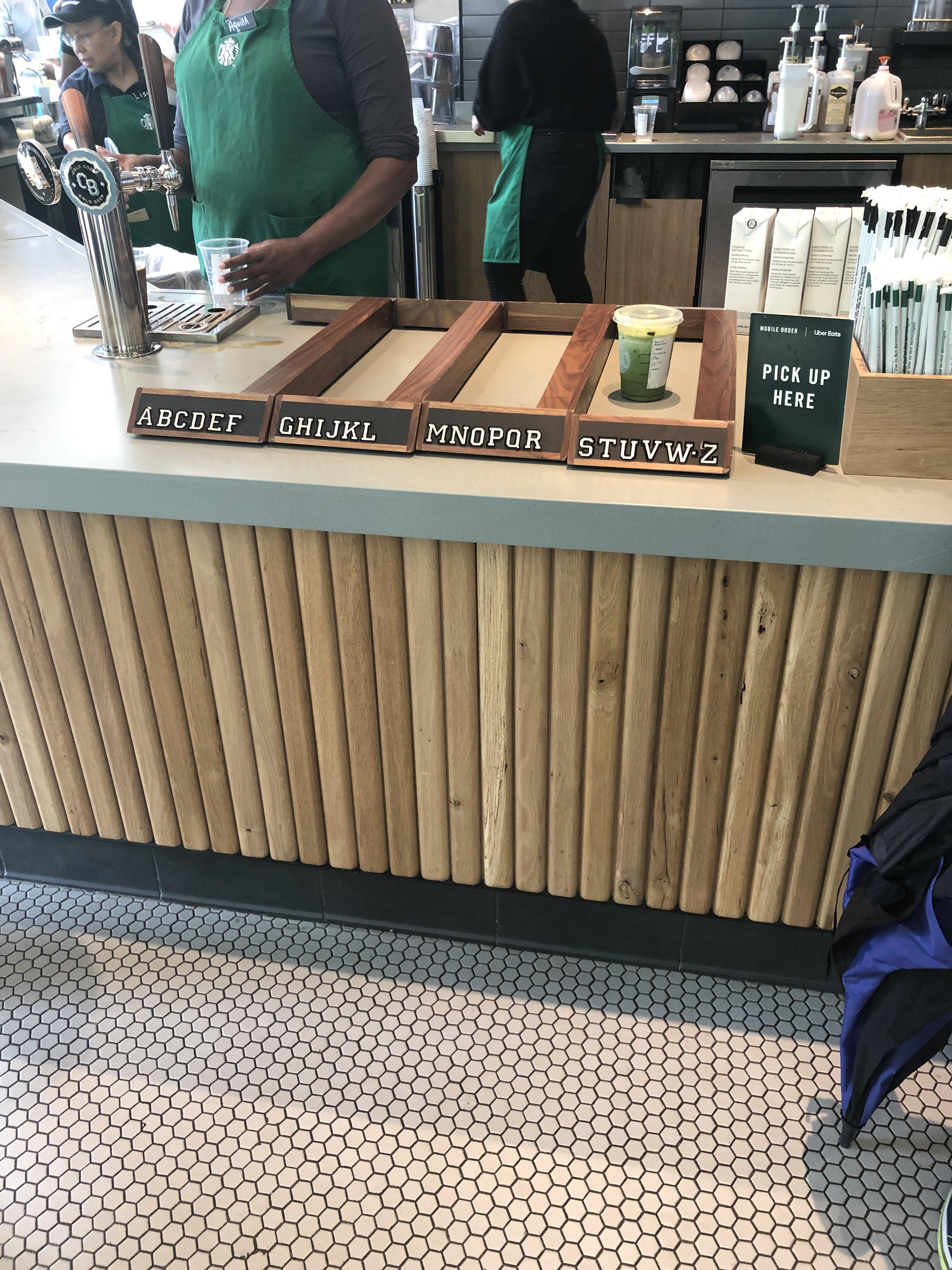 This Starbucks has their pickup counter separated by name r