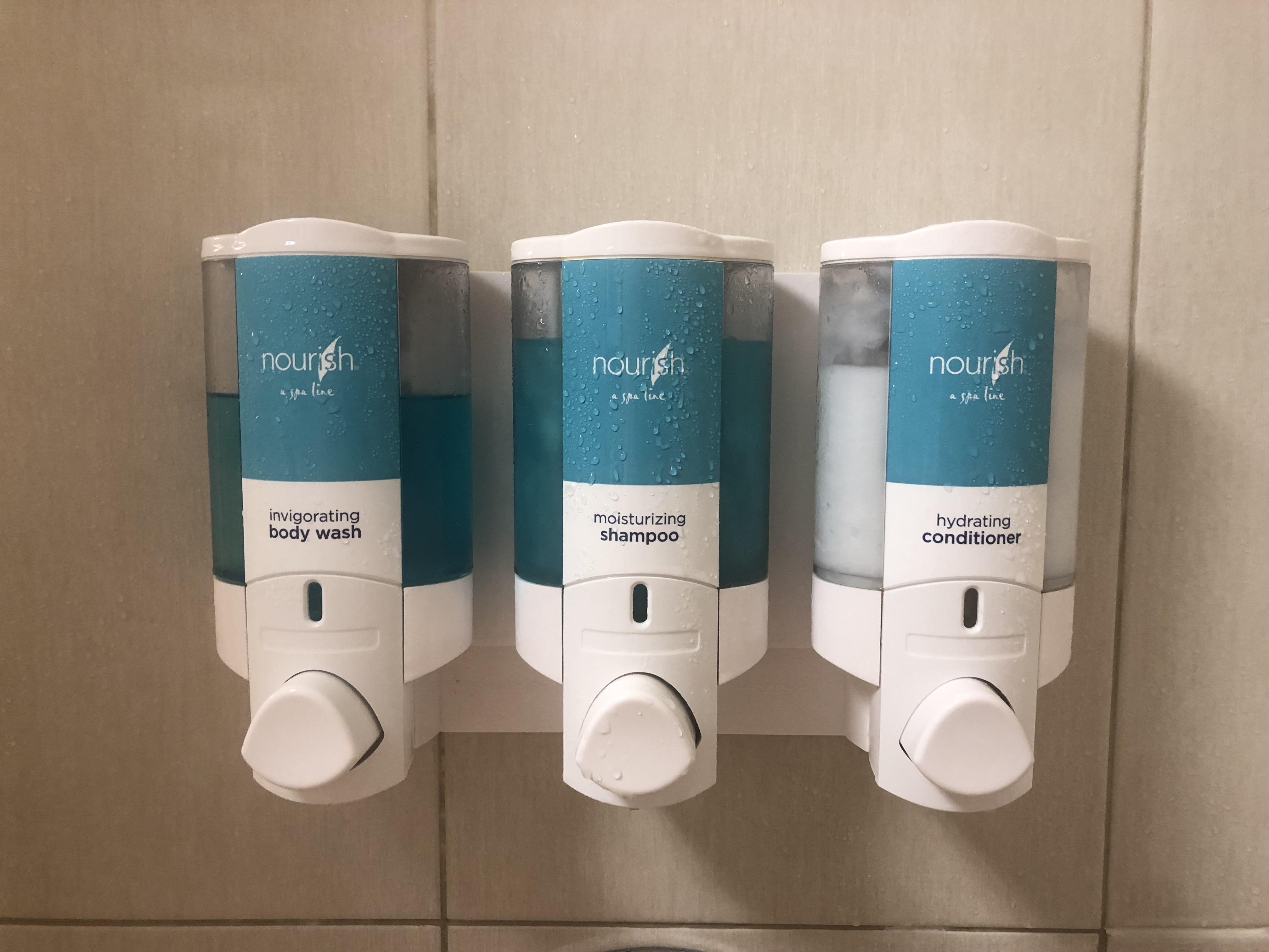 This hotel gives you dispensers of shower essentials instead of travel