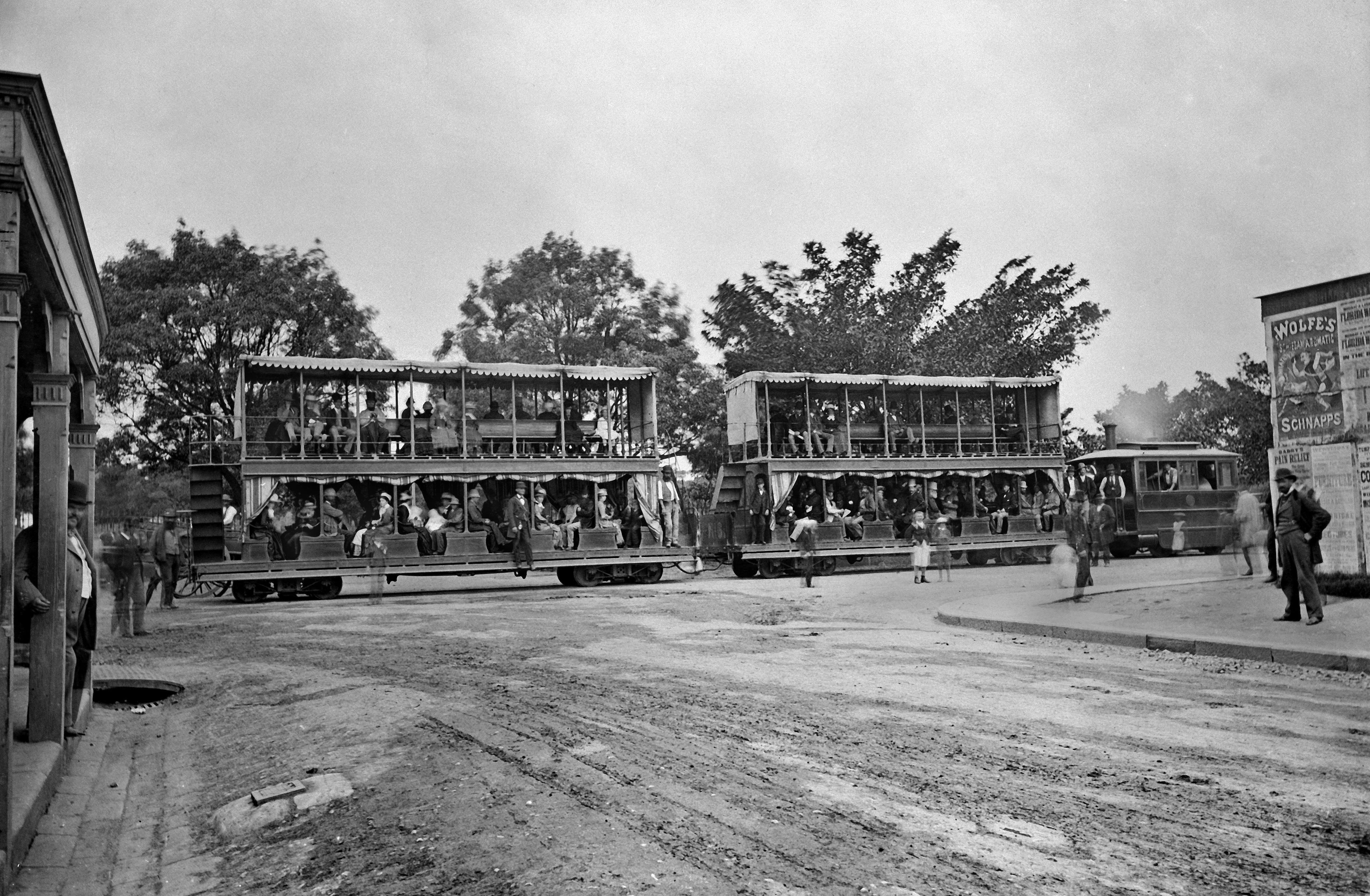 Double decker steam tram travels south on Elizabeth Street, at the