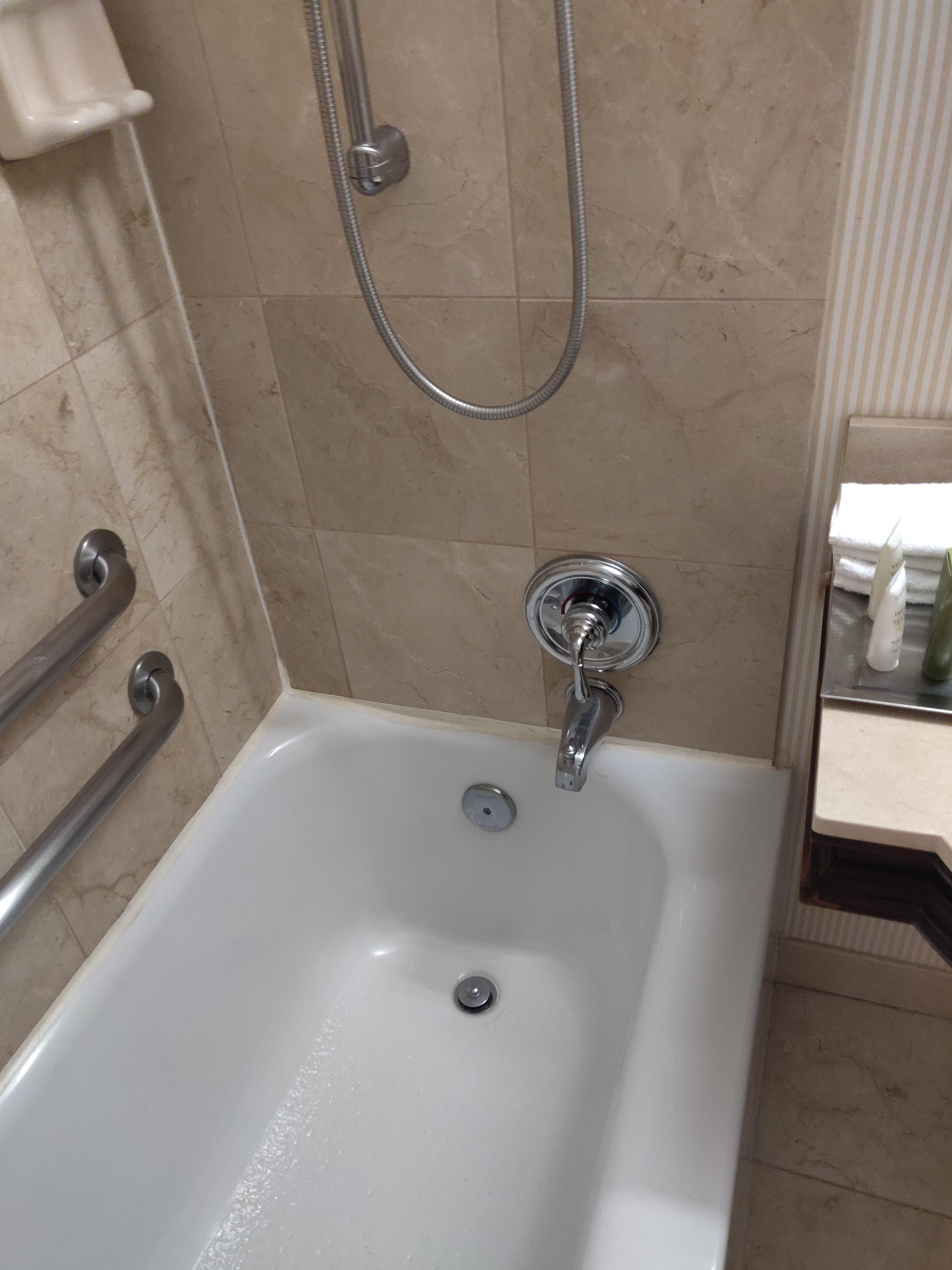 The bathtub faucet at my hotel is off center by a lot. r