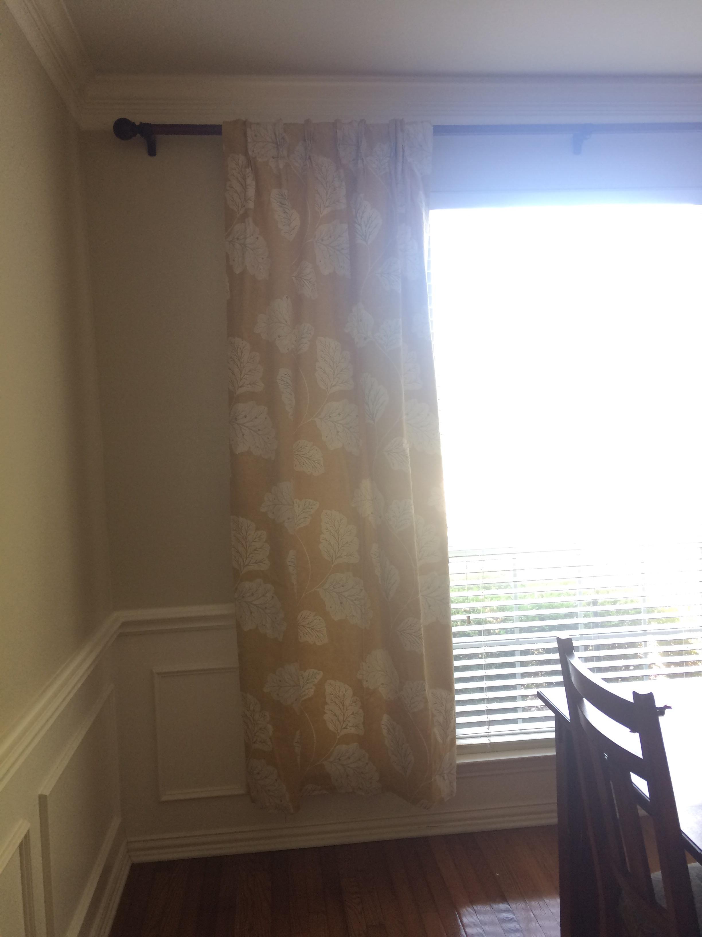 Somebody installed the curtain rod hooks too high, so a normal sized