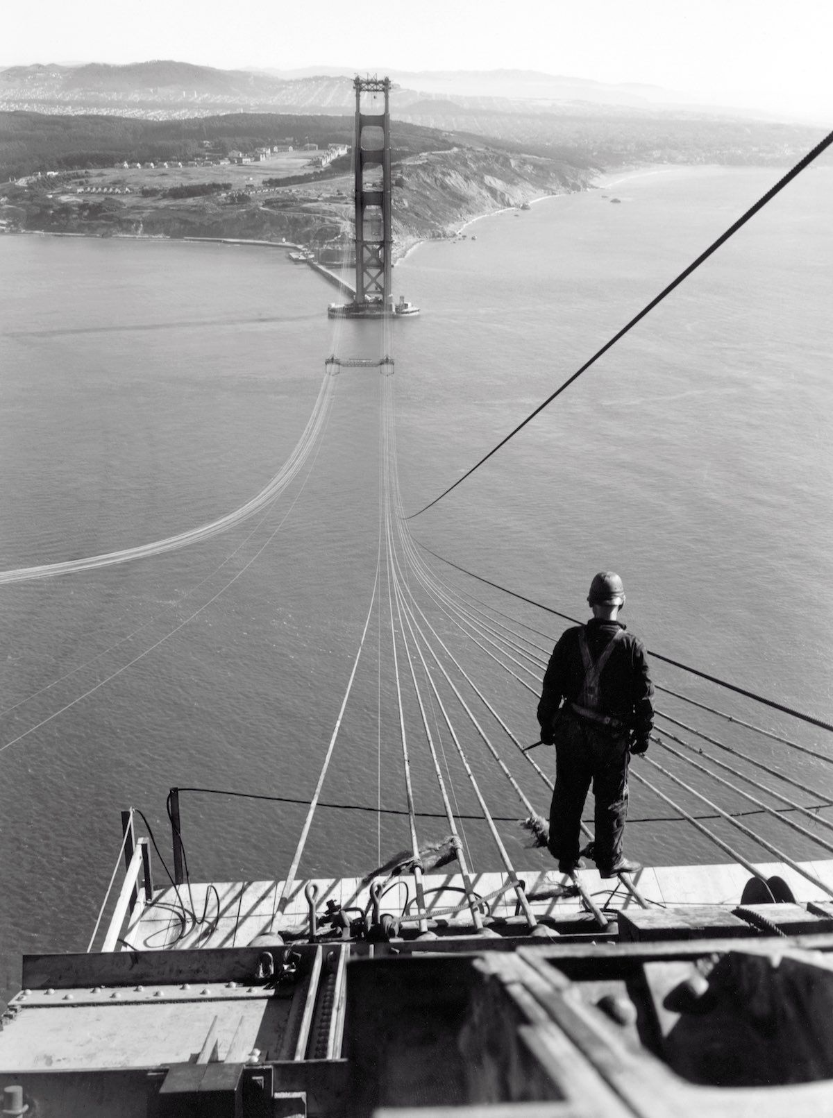 Man standing on the first cables of the Golden Gate Bridge
