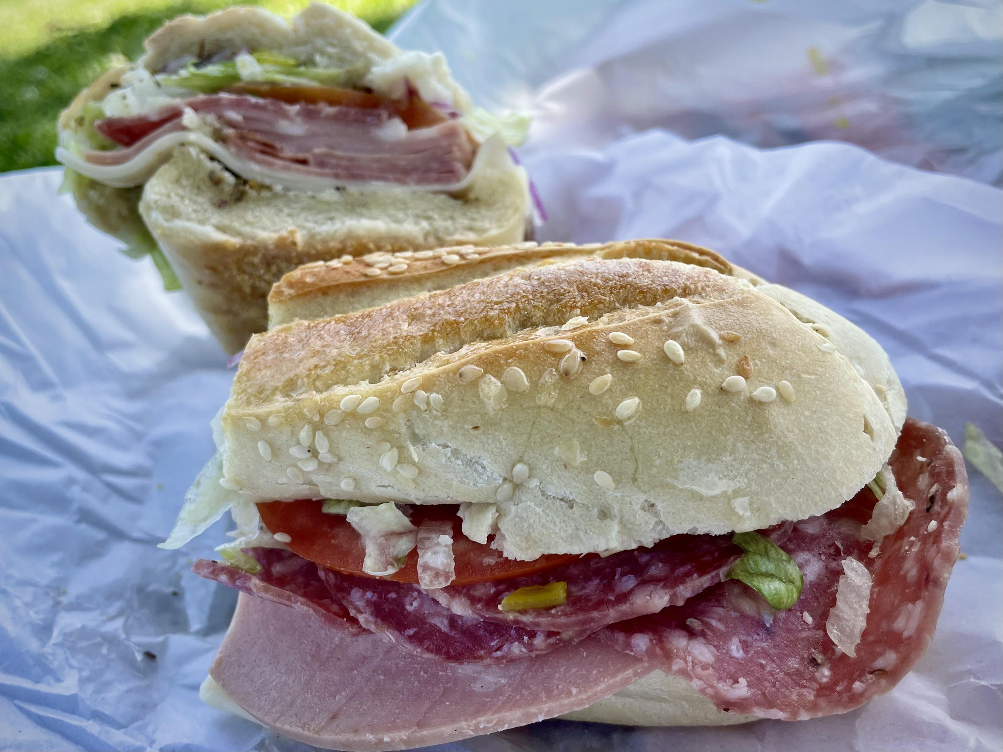 Italian dry and cotto salami, mortadella, and provolone, on a crusty