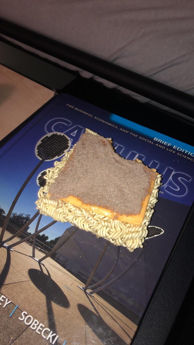 Ramen with a Kraft single and the seasoning schmeared on top r