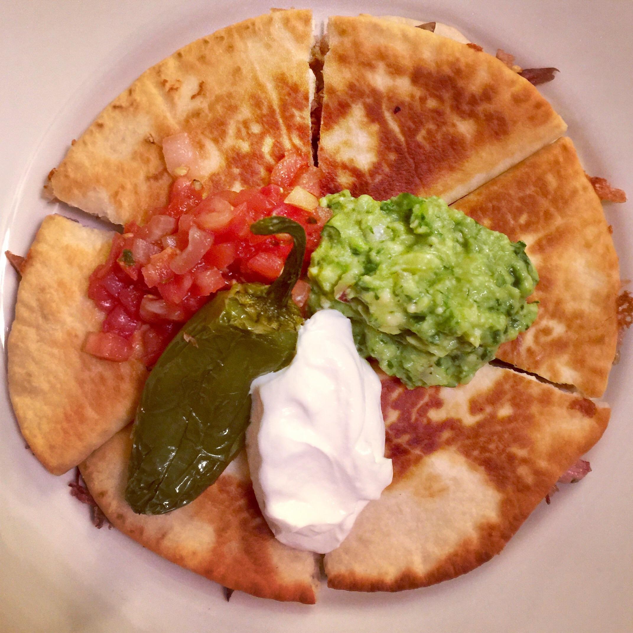 Cheesy Carnitas Quesadilla with Homemade Guacamole, Sour Cream and