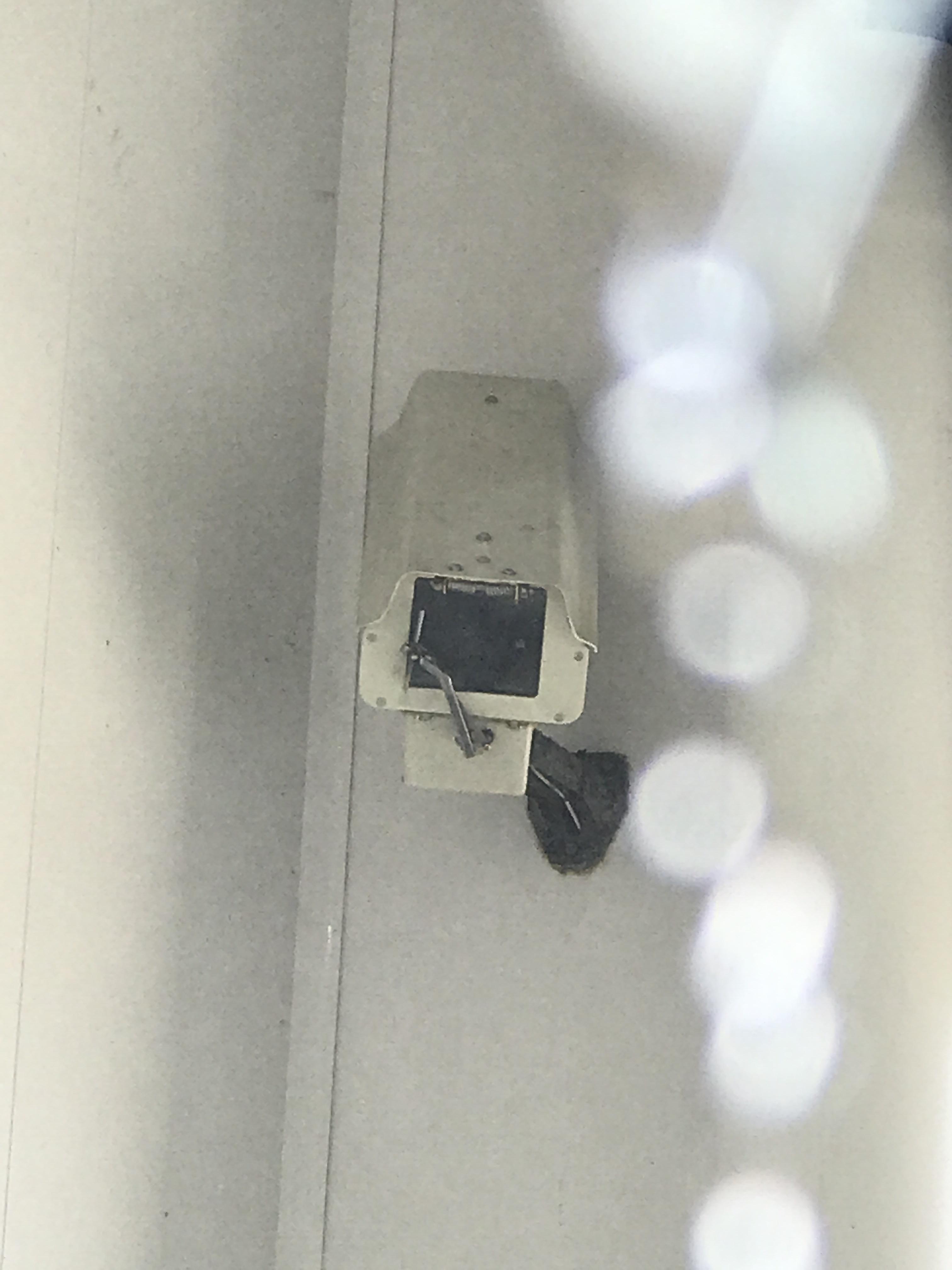 This security camera in the car wash has a wiper blade r