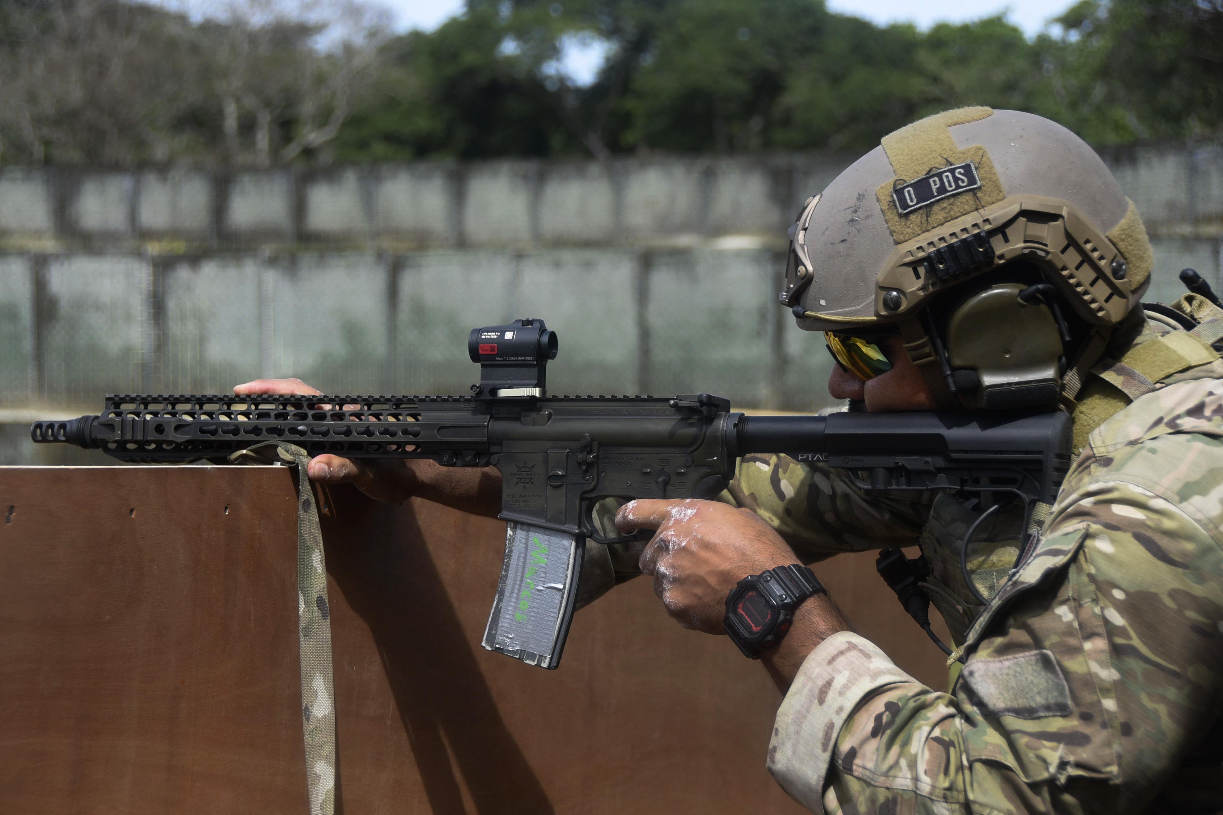 A U.S. Army Green Beret takes aim firing his weapon at targets from