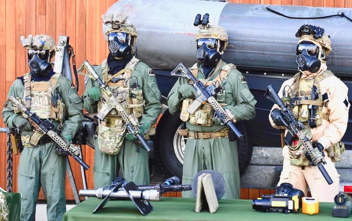 Australia's Tactical Assault Group East (TAGE) stands together as they pose for members of the