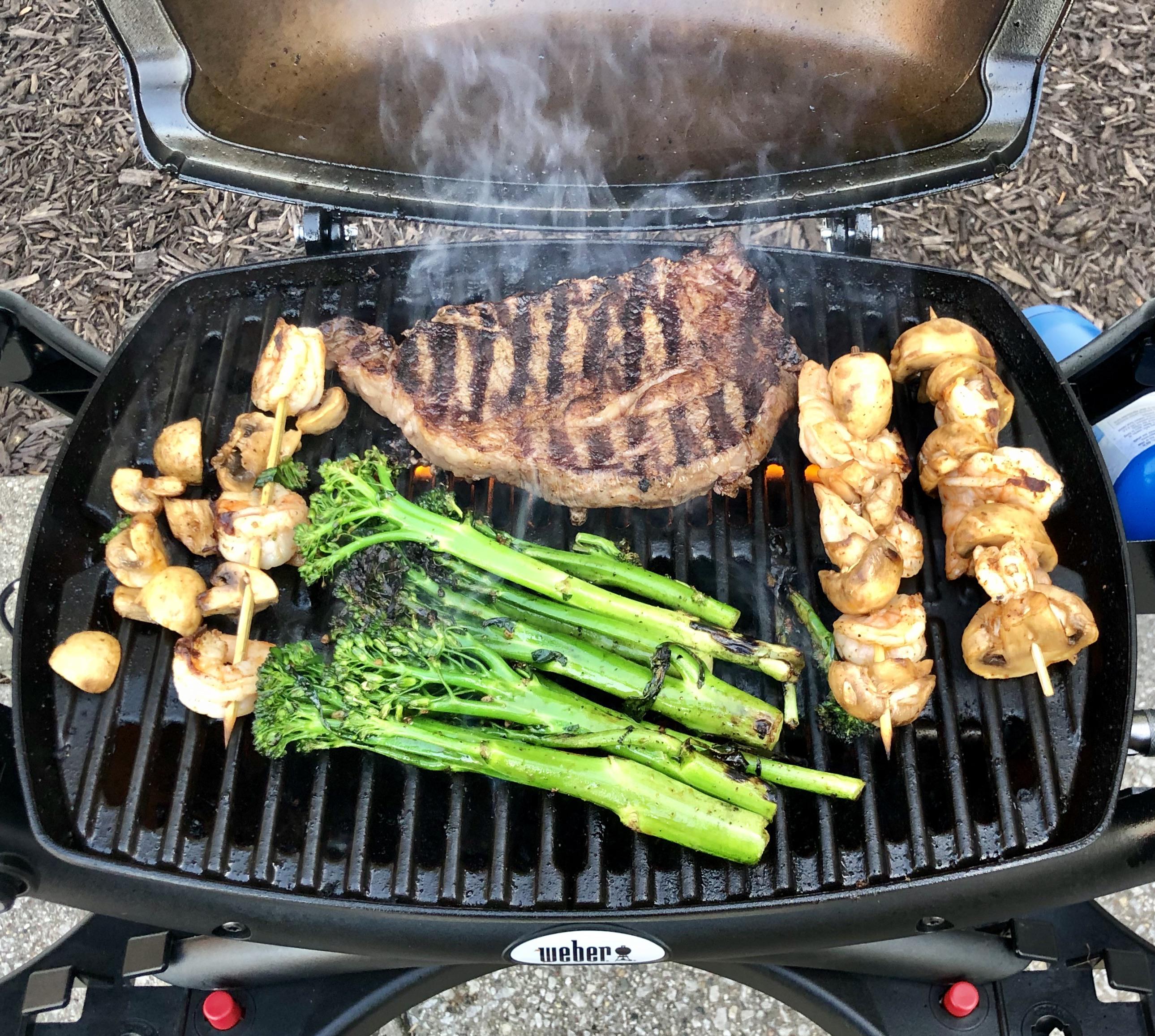 er Q loaded up! Ribeye, broccolini, skewered shrimp and mushrooms