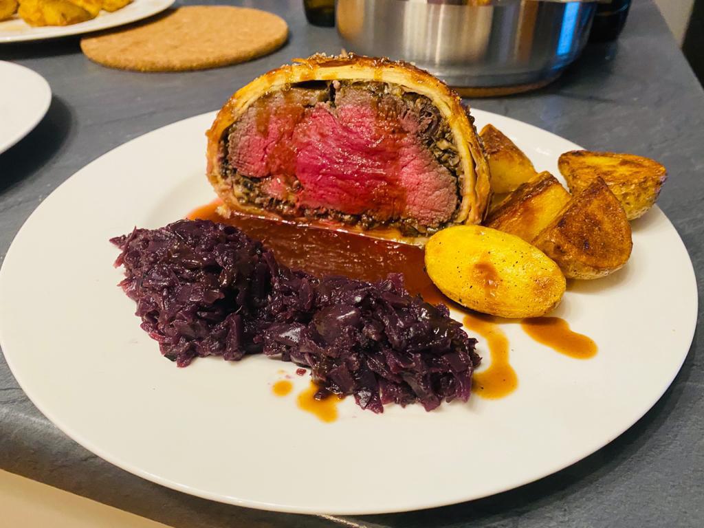Beef wellington, red wine demi glace sauce, braised red cabbage and some parboiled and pan