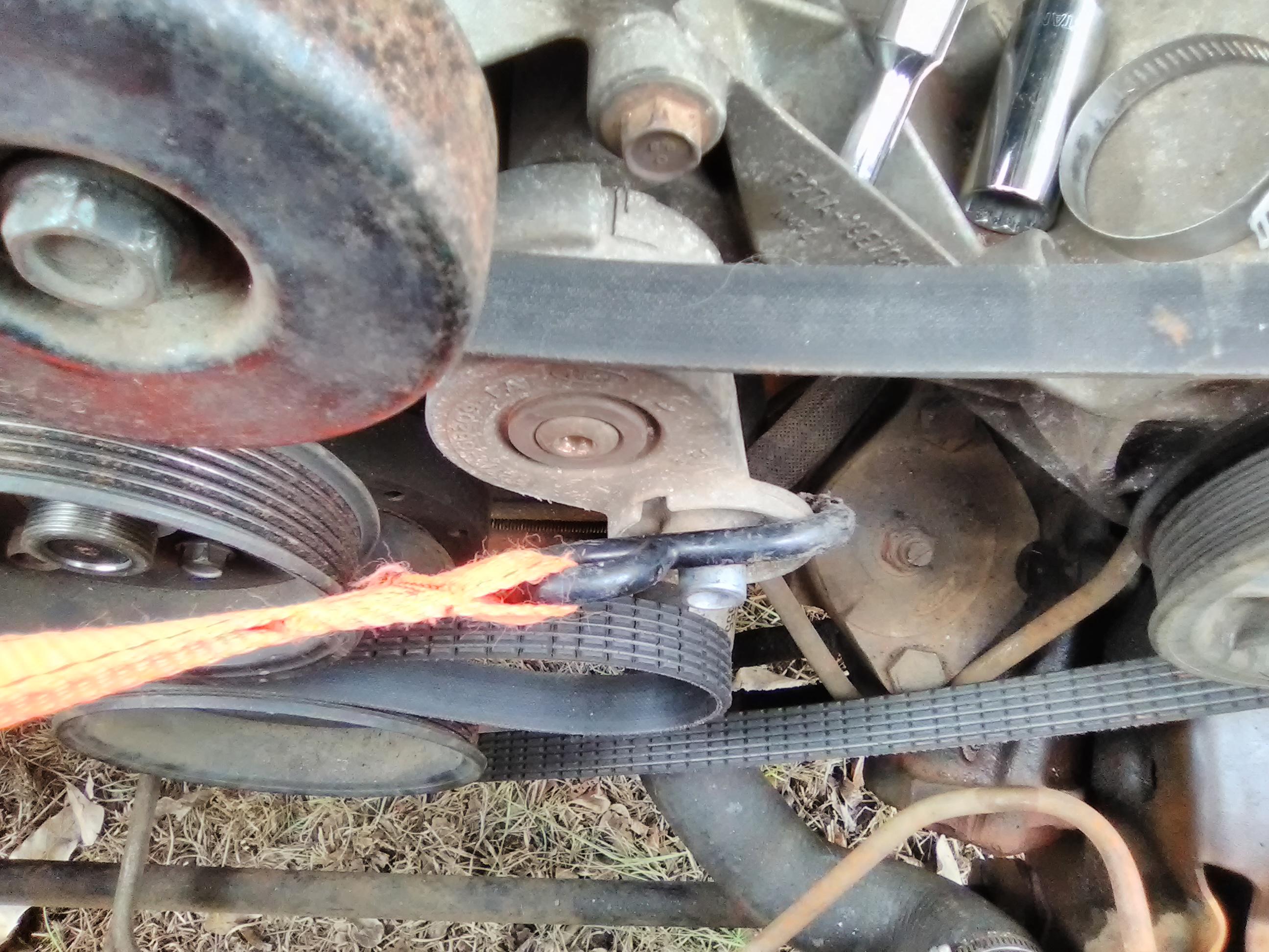 Any idea how I can easily move the tensioner so I can get the belt back