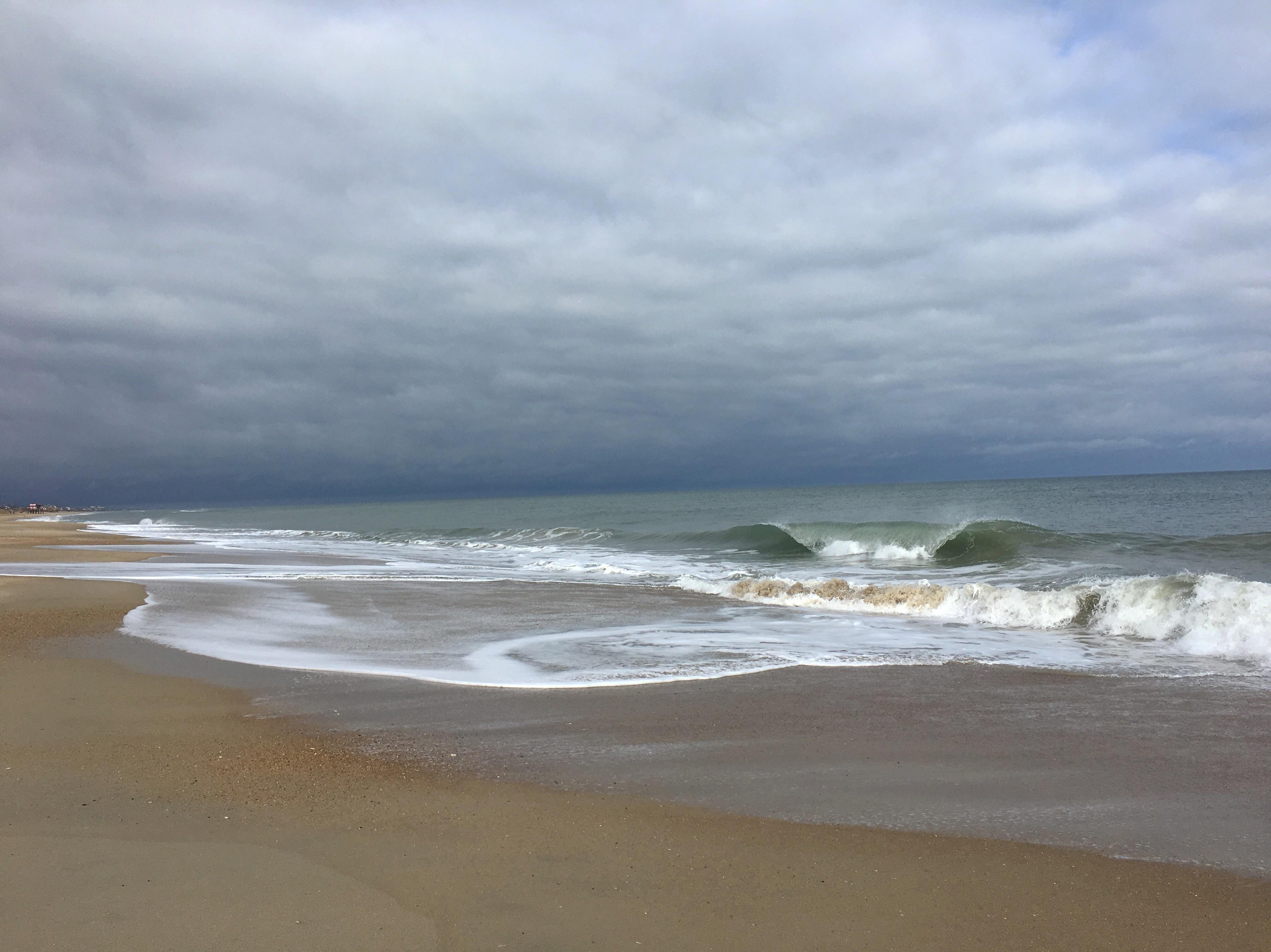 Wave crashing under gray sky in Kitty Hawk, NC. [4032 x 3024] [OC] r
