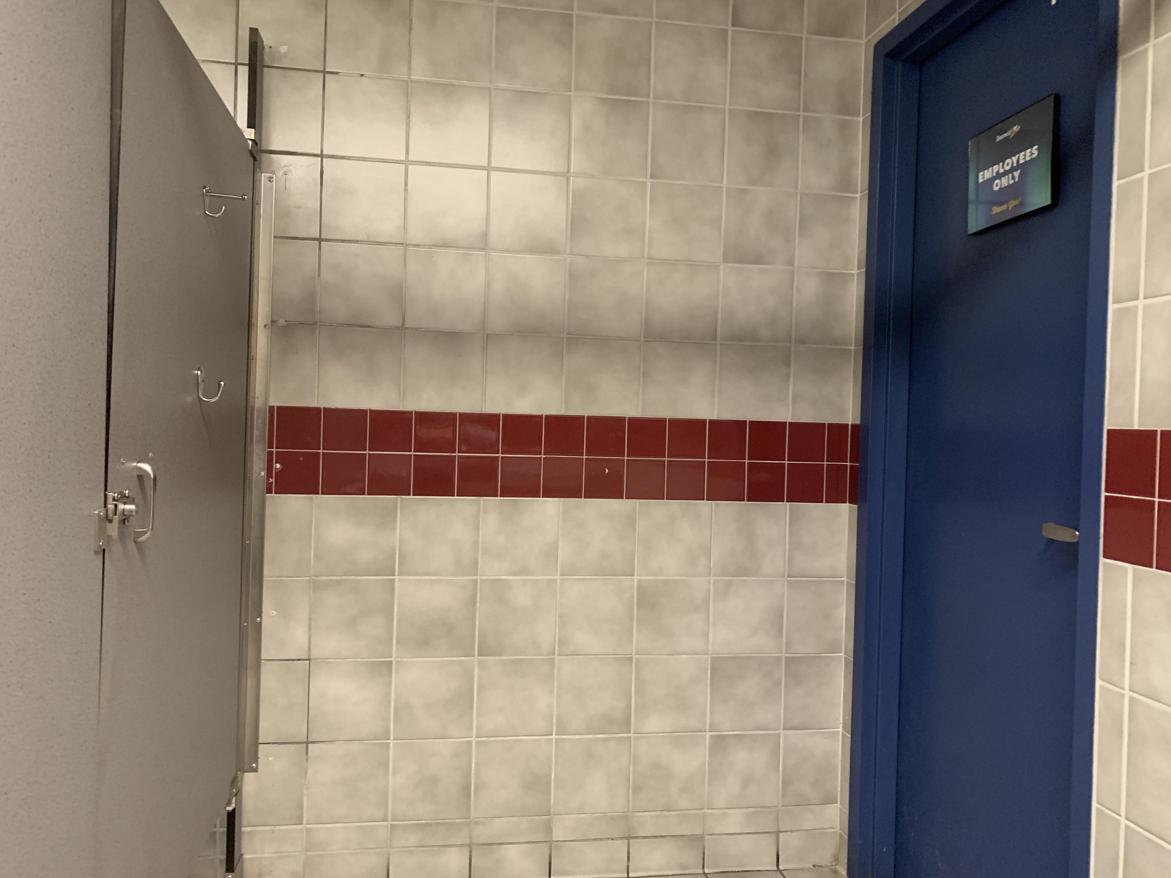 This (handicapped) bathroom stall has an "Employees Only" room