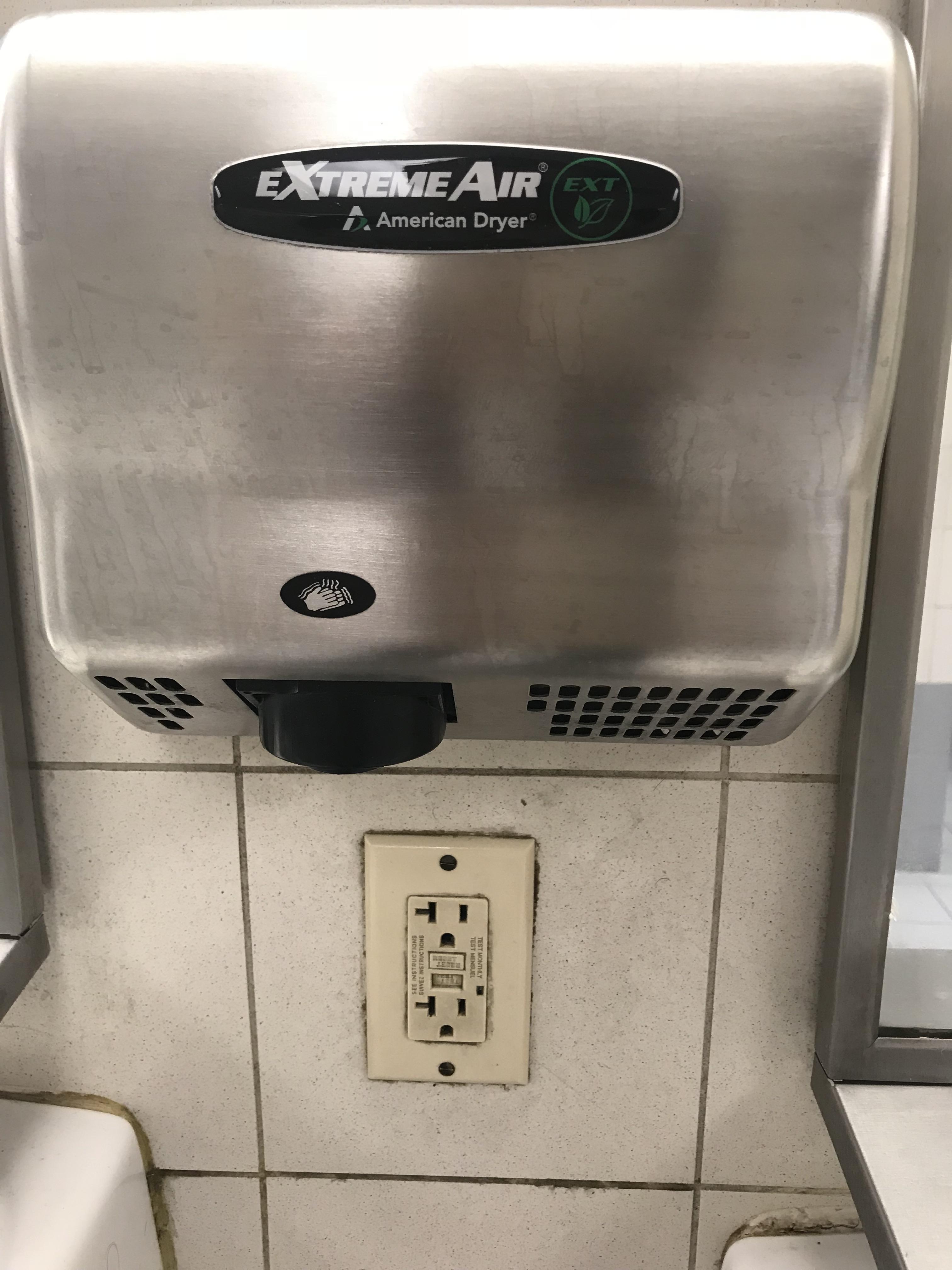 Someone got paid to either fit the outlet under the hand dryer, or fit