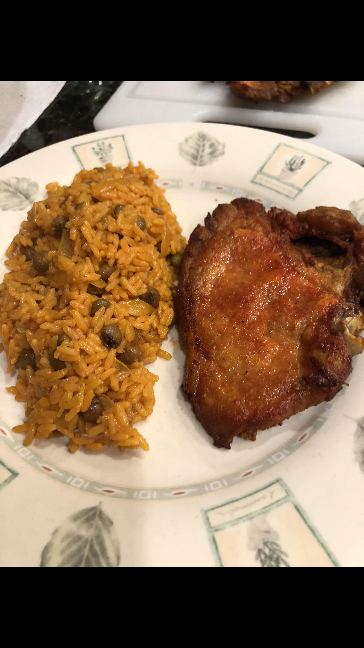 A Puerto Rican classic homemade Spanish rice and fried pork chops