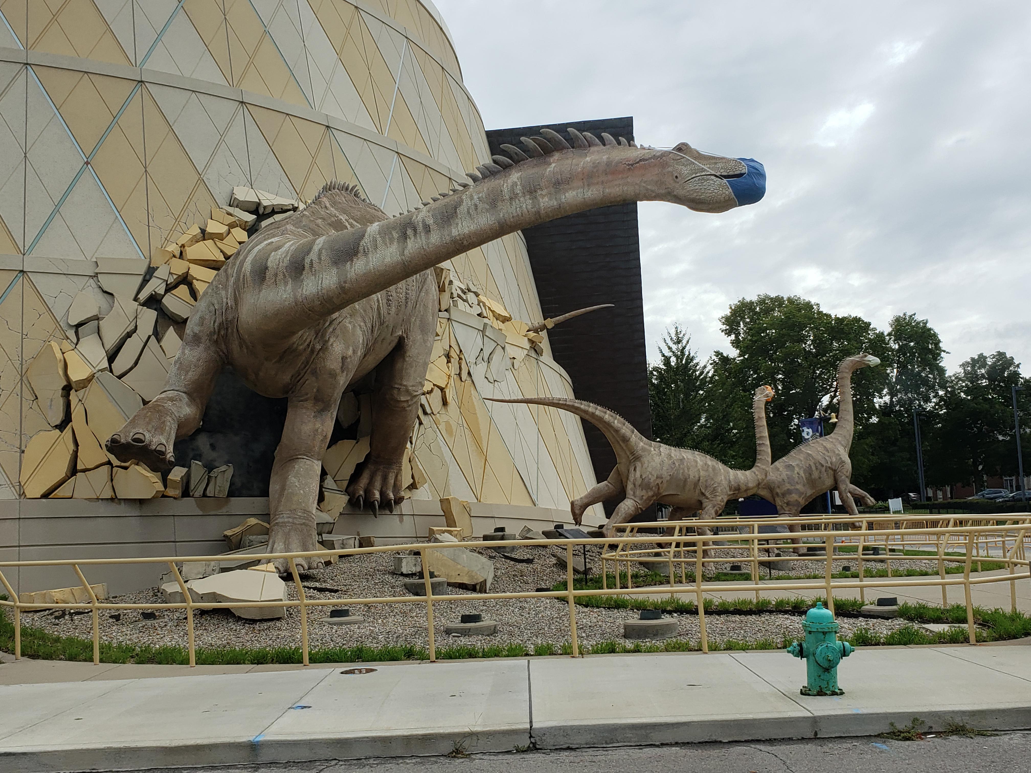These dinosaurs wearing masks at the Indianapolis Children's Museum r