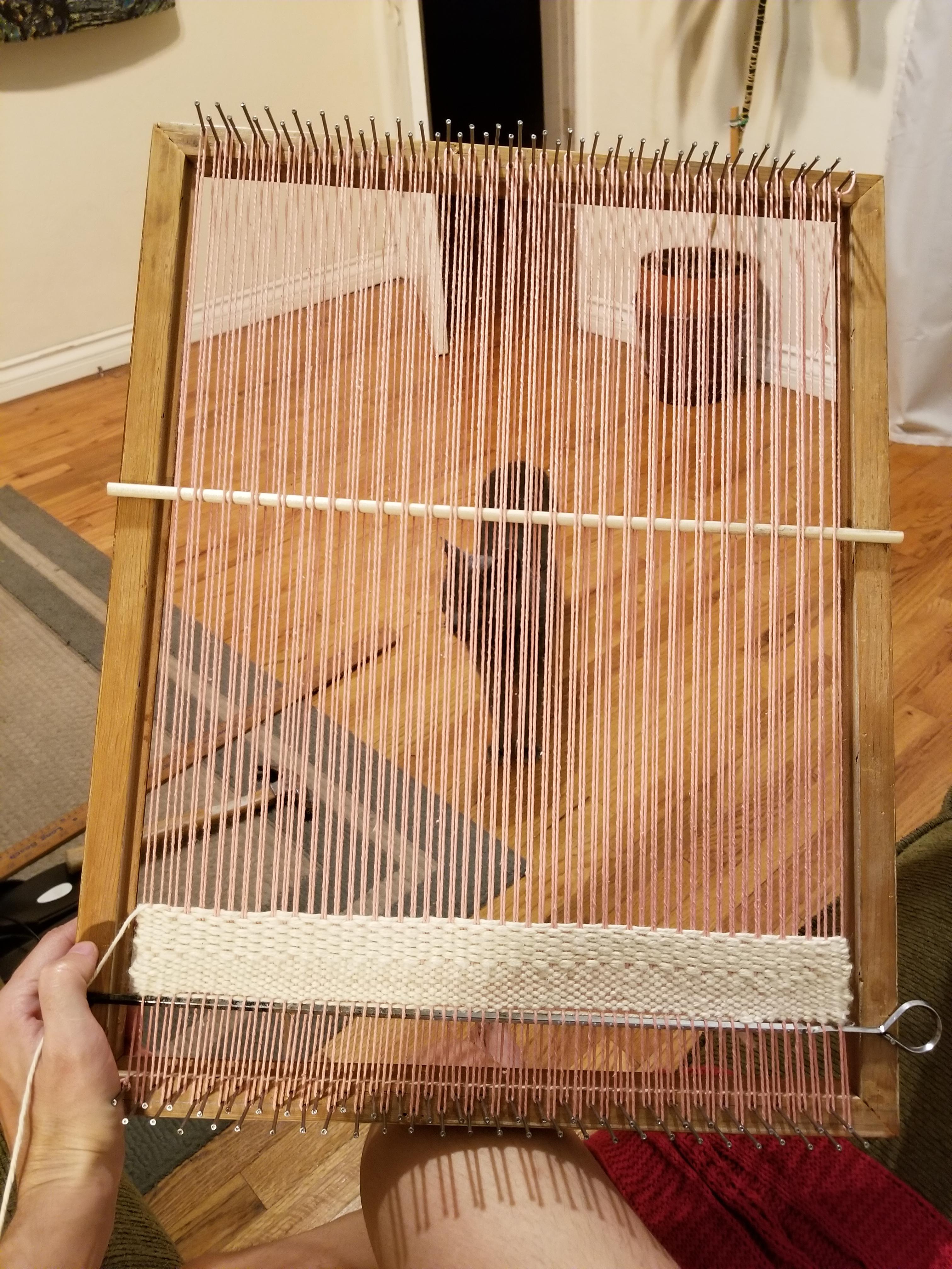 A simple loom fashioned with an old picture frame and some finishing