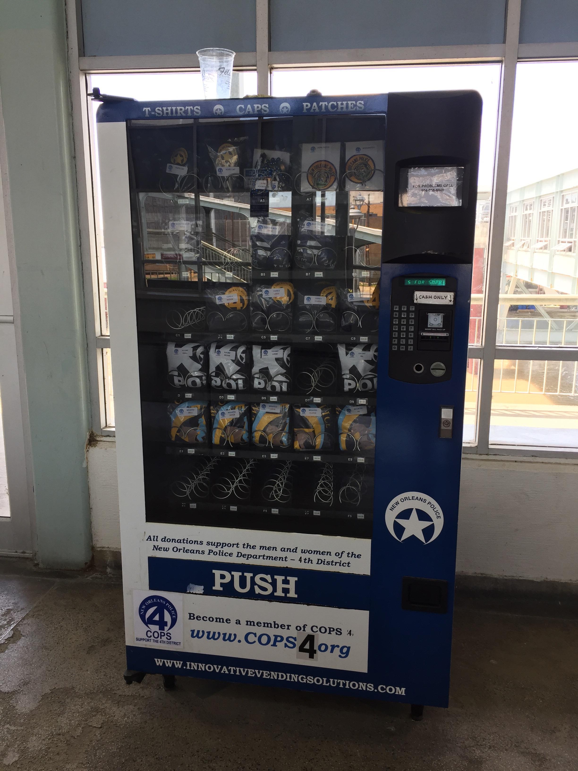This vending machine sells tshirts, caps, and patches benefitting the