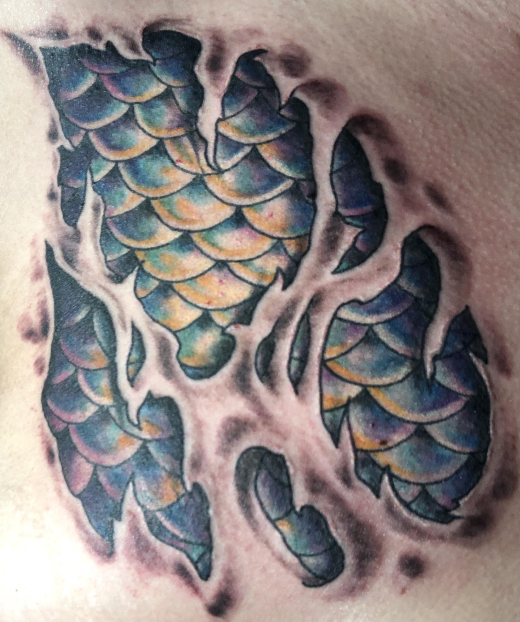 Torn skin w/ mermaid scales from Brad Schneider at 454 Tattoo in