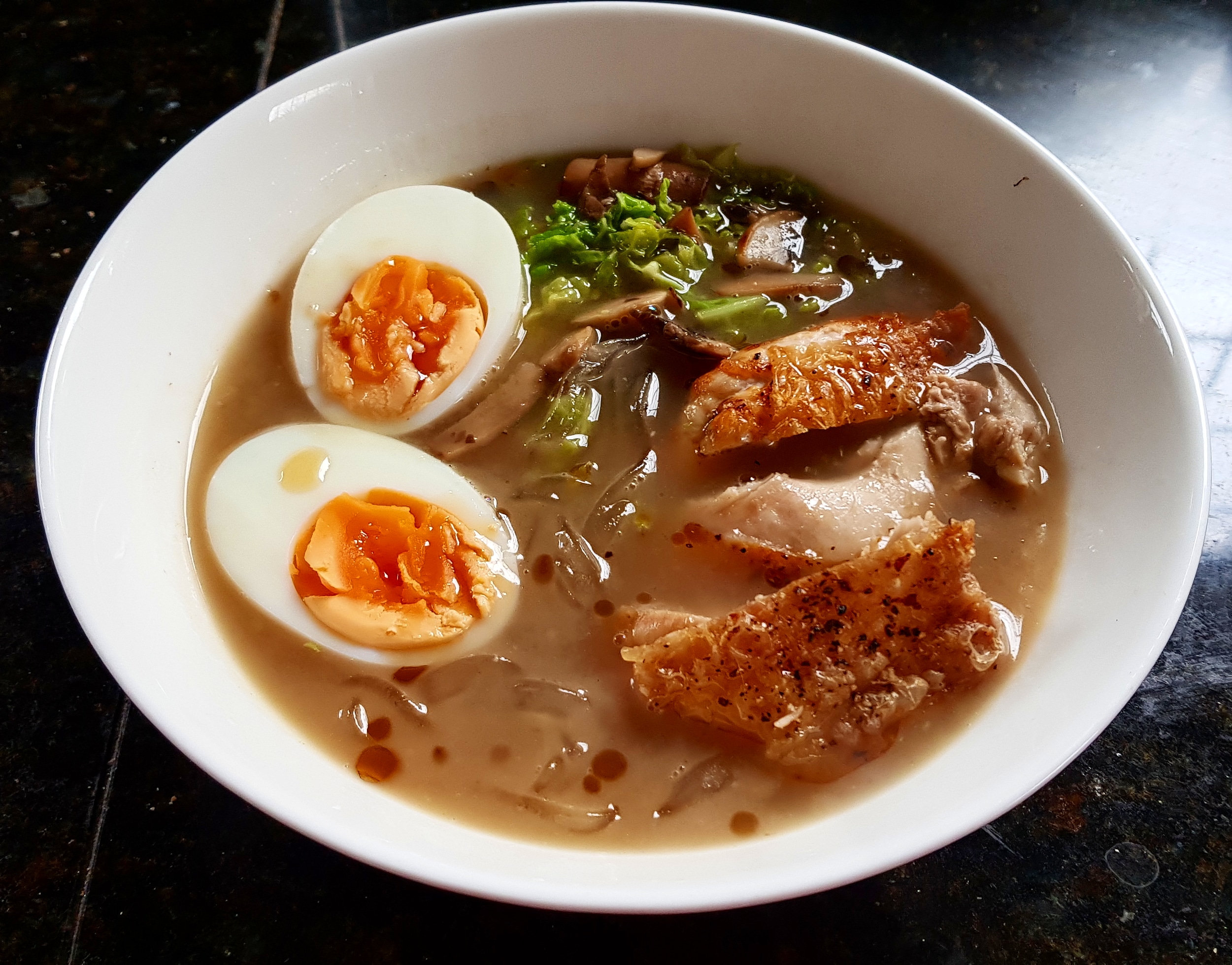 Duck stock with cabbage, mushroom, chicken thigh, noodles and a boiled