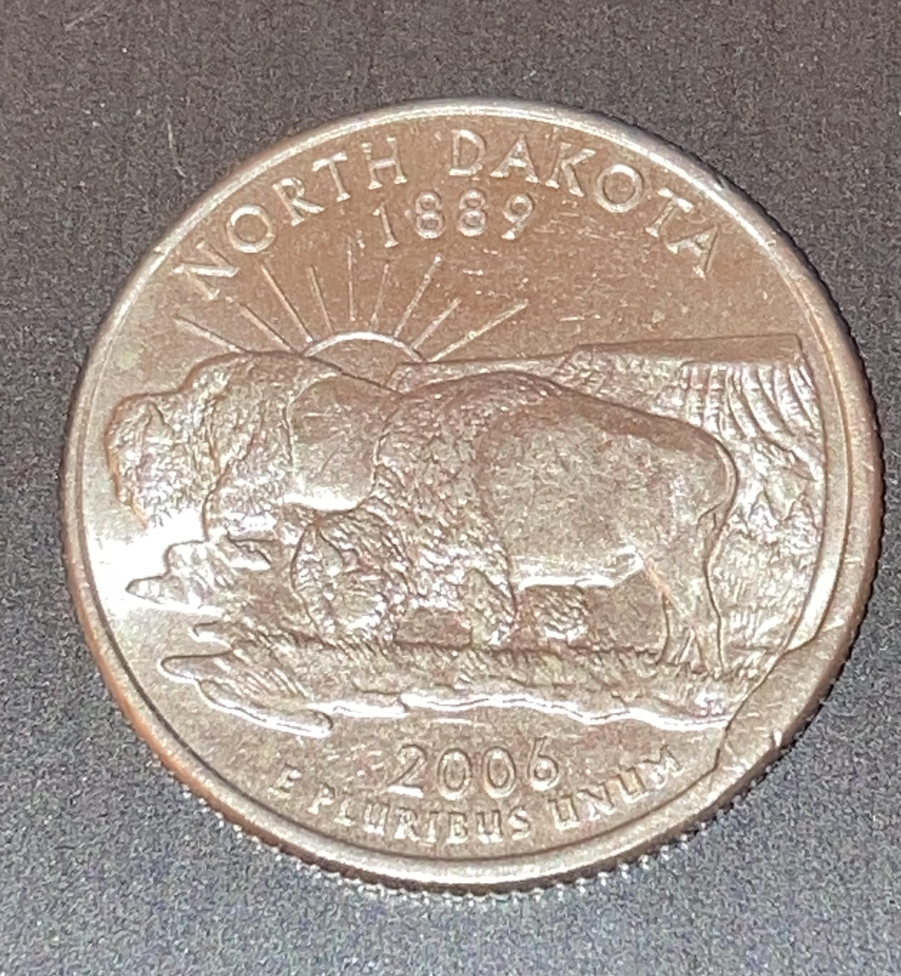 Found a 2006 North Dakota Quarter with what looks like a cud at 4 o