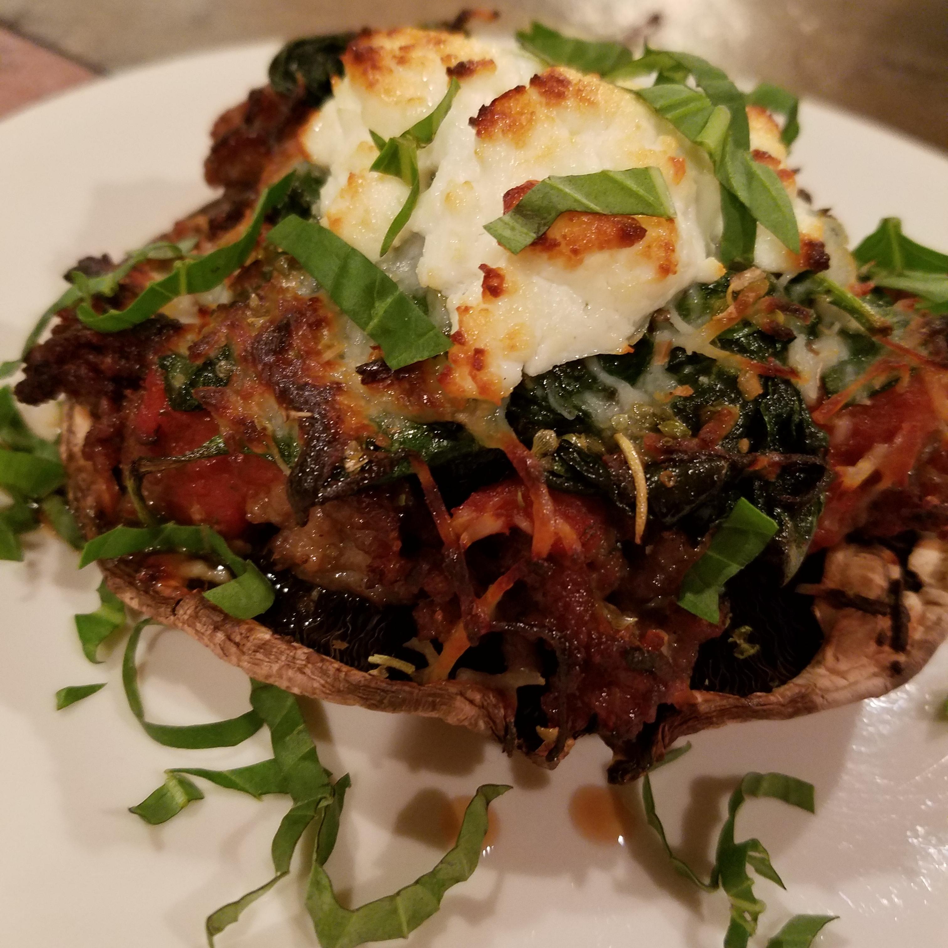 Baked portabella cap stuffed with Italian sausage, spinach, and goat