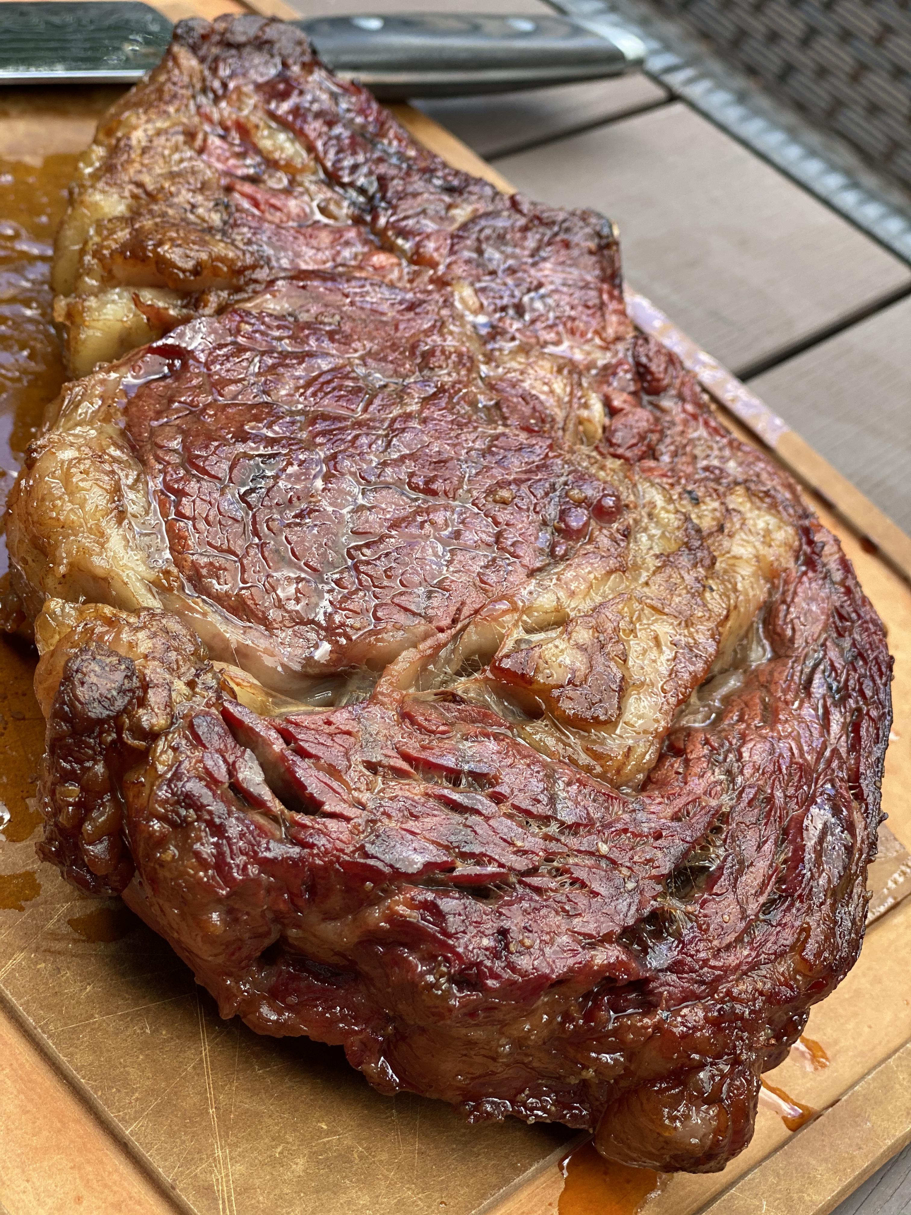 Giant grass fed ribeye after searing r/steak