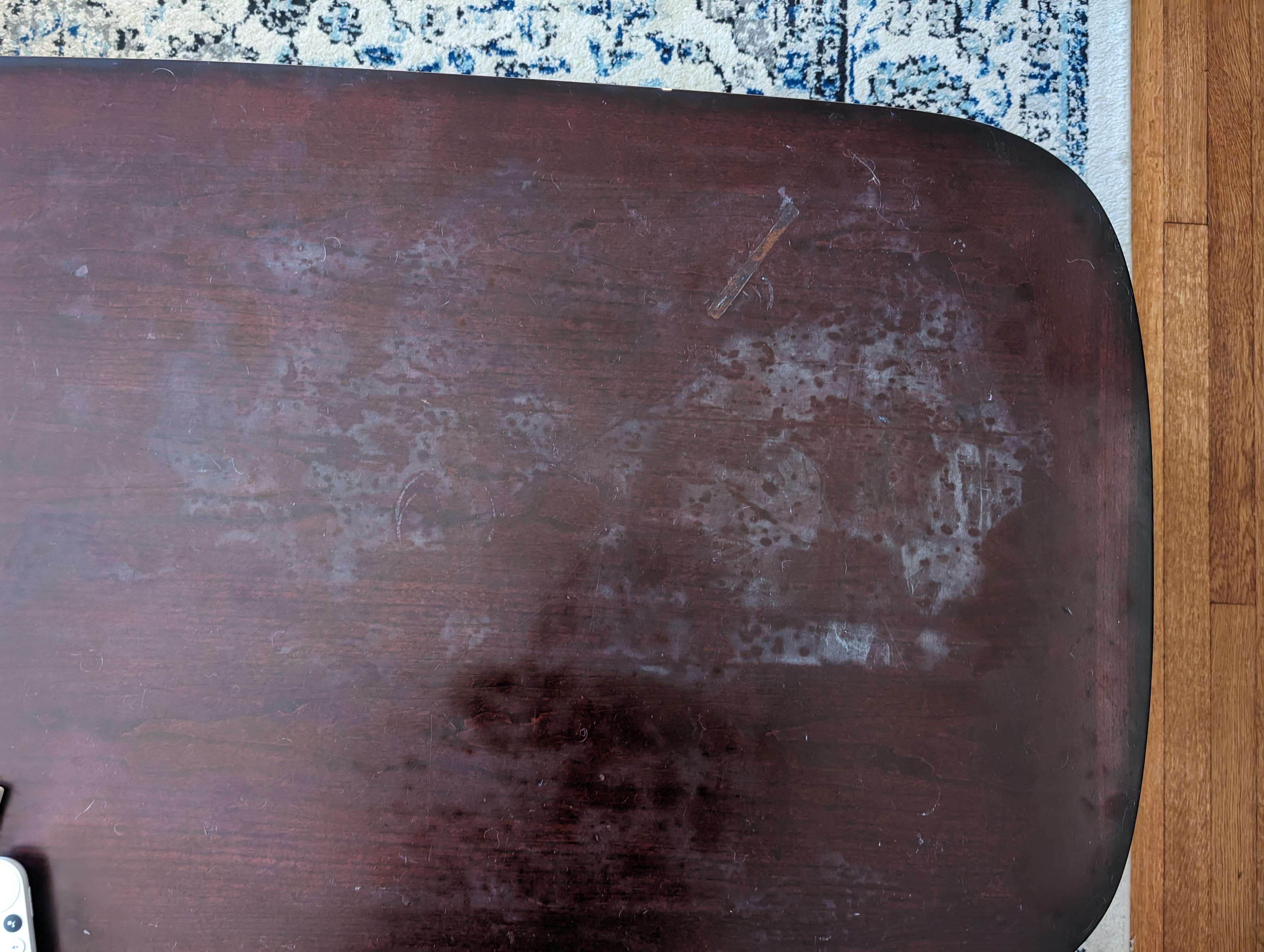White discoloration caused by rubbing alcohol on wood table r/fixit