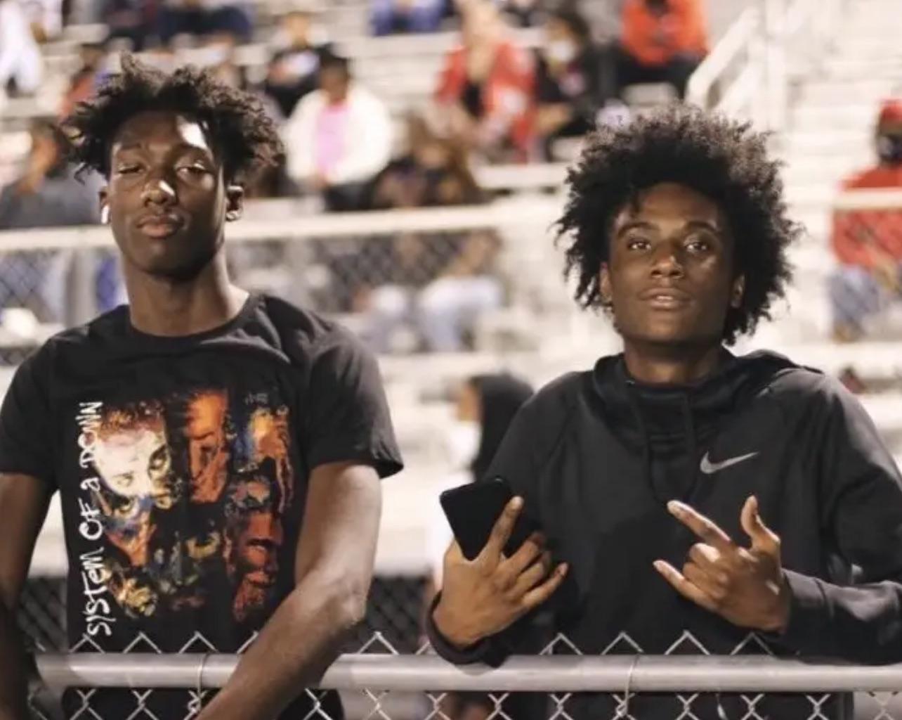 Young Osamason and his friend cheering on the Goose Creek Football team