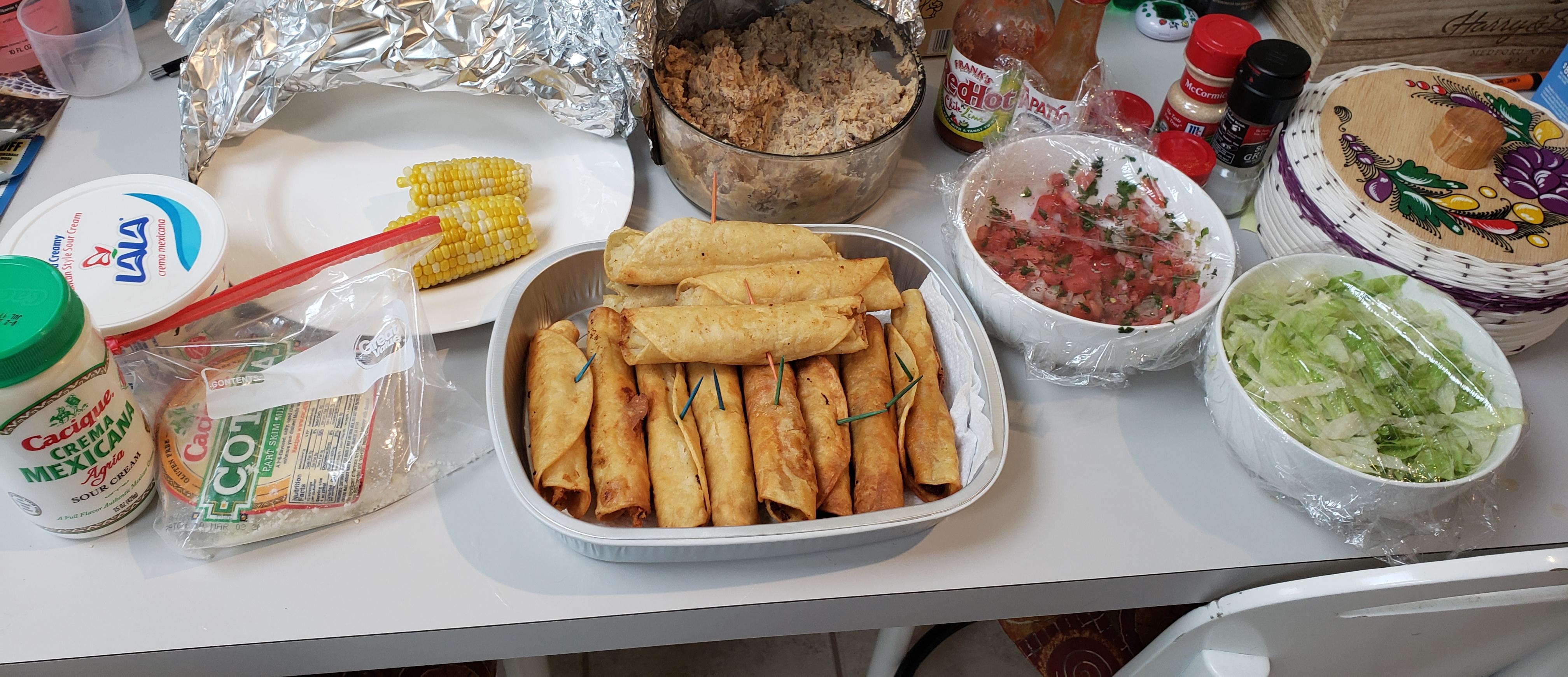 Chicken,chorizo,and potato flautas with corn and refried beans I made