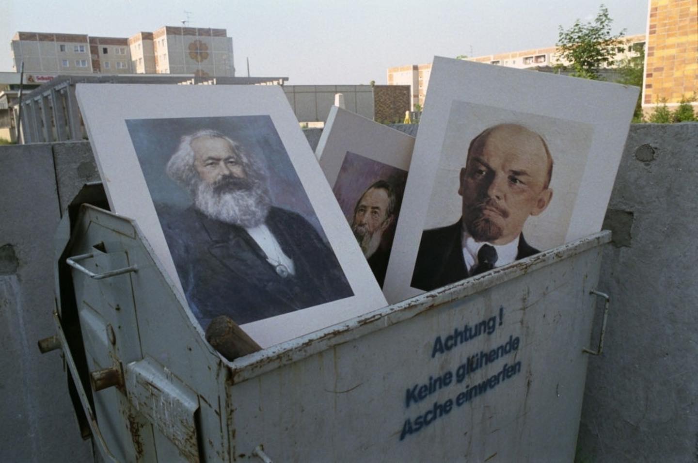 Portraits of Karl Marx and Vladimir Lenin, are dumped in garbage