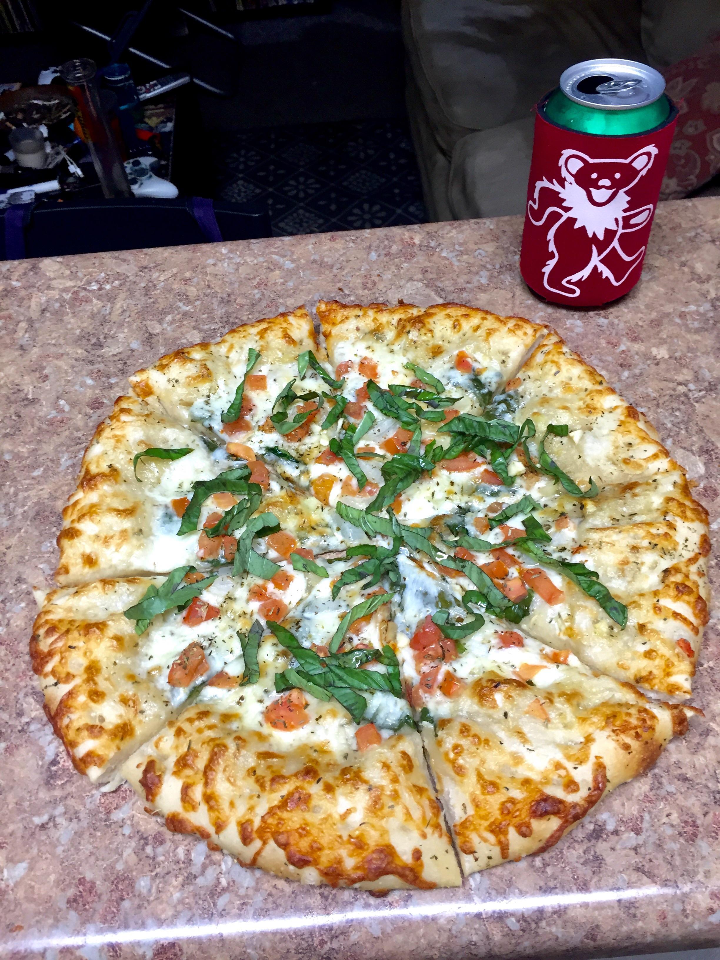 Olive oil and herb based margarita pizza and a rolling rock r