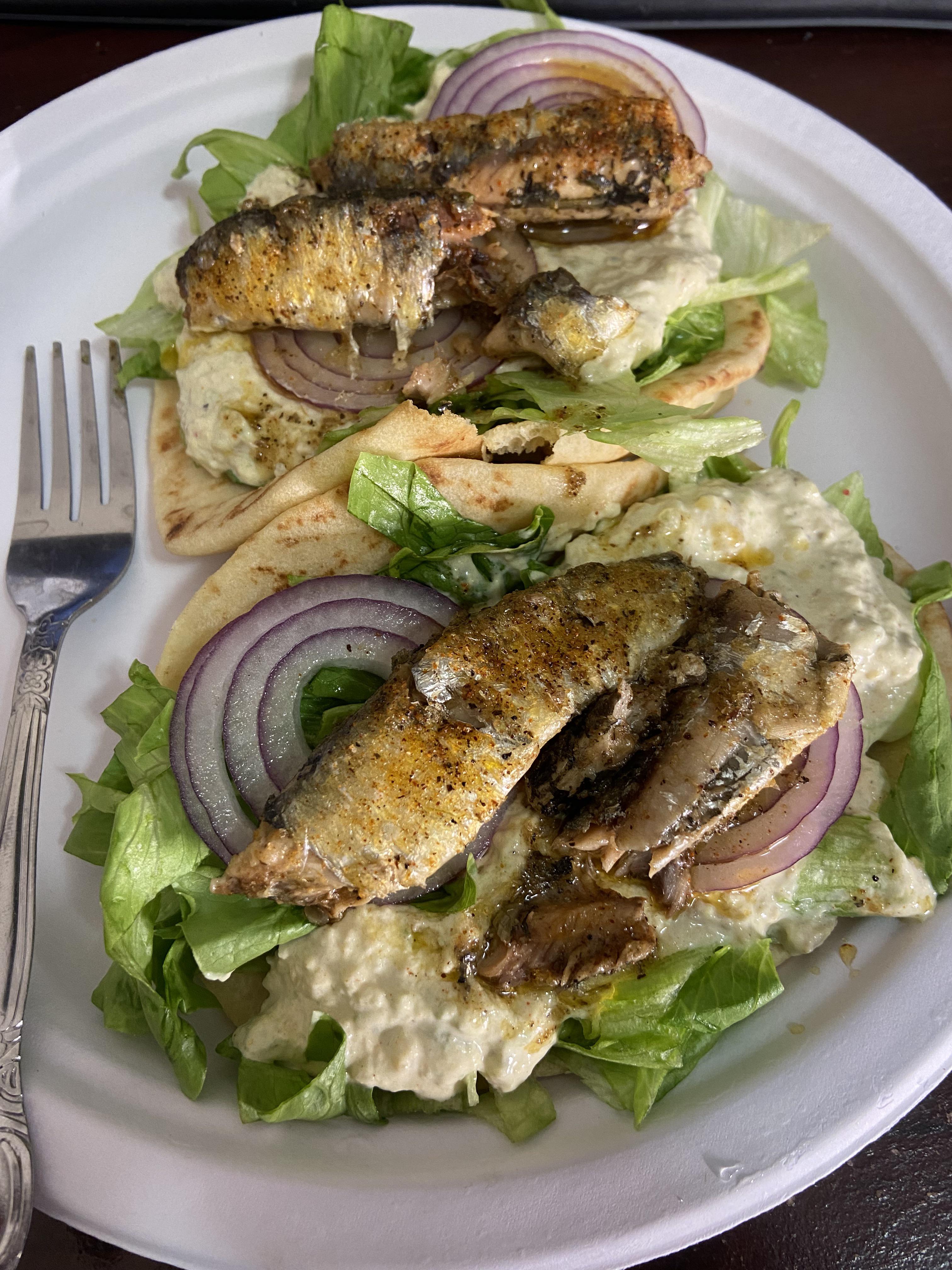Lunch! Cajun seasoned fried sardines over avocado, red onion and