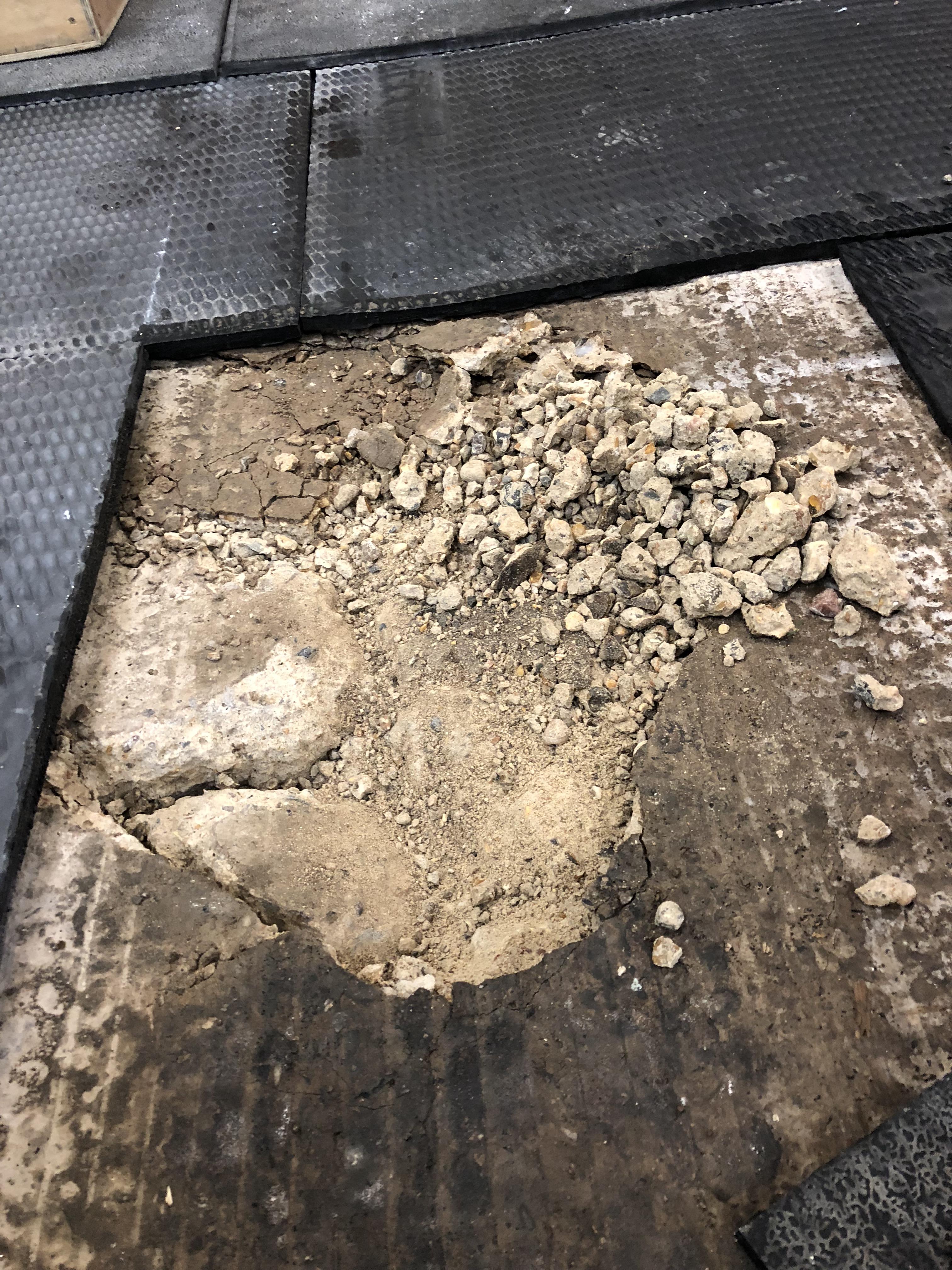 Sub floor crumbling! This is under 2 layers of matting the bars being