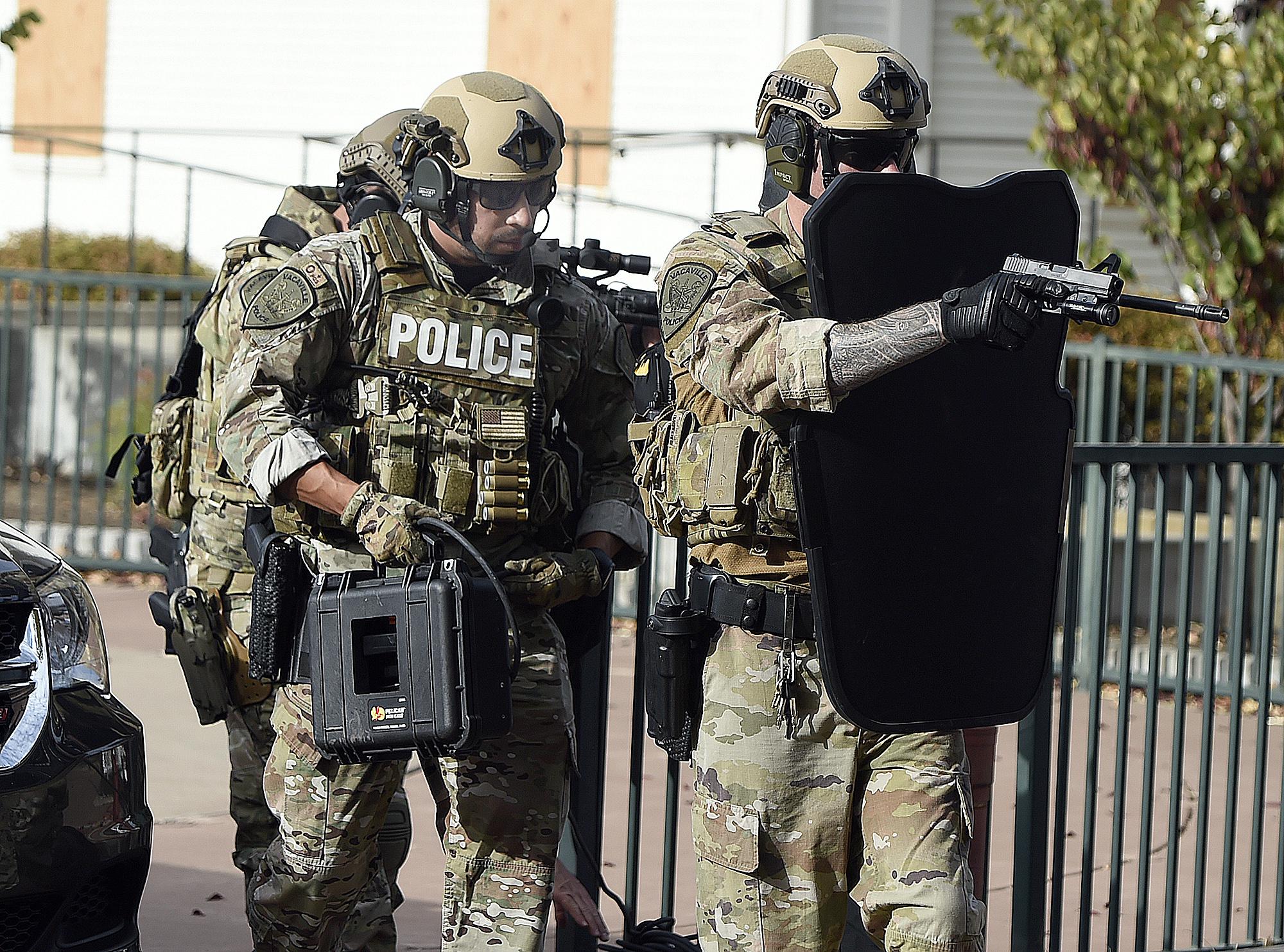 Vacaville PD SWAT with phone box advancing toward a Starbucks during