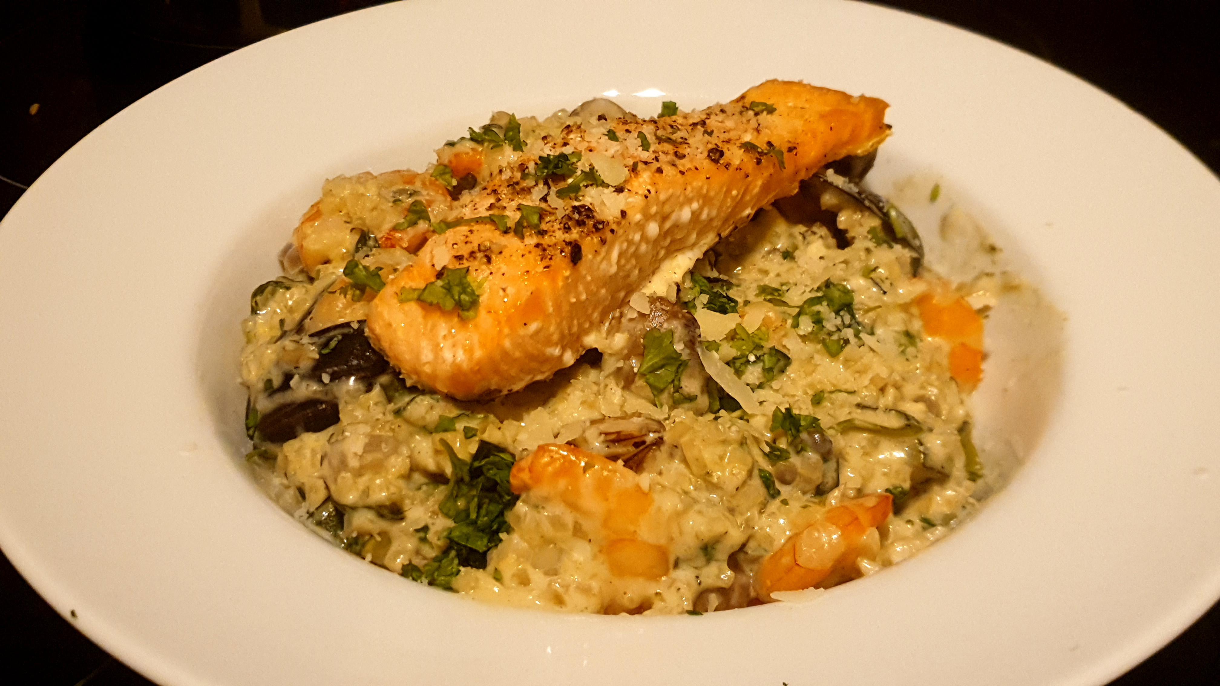 Seafood "risotto" topped with a salmon fillet. r/Ketomealseatingnow
