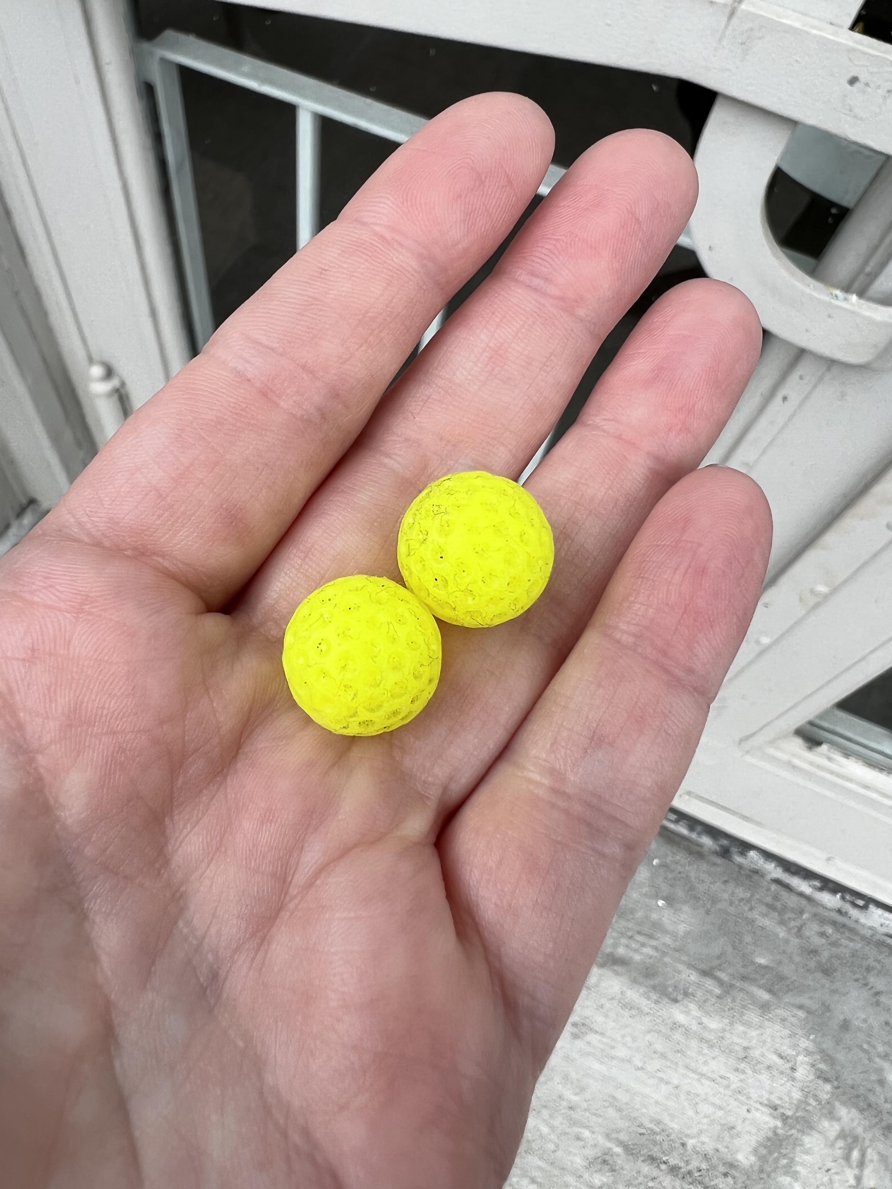 Squishy rubber balls a little less than 1/2 inch in diameter with