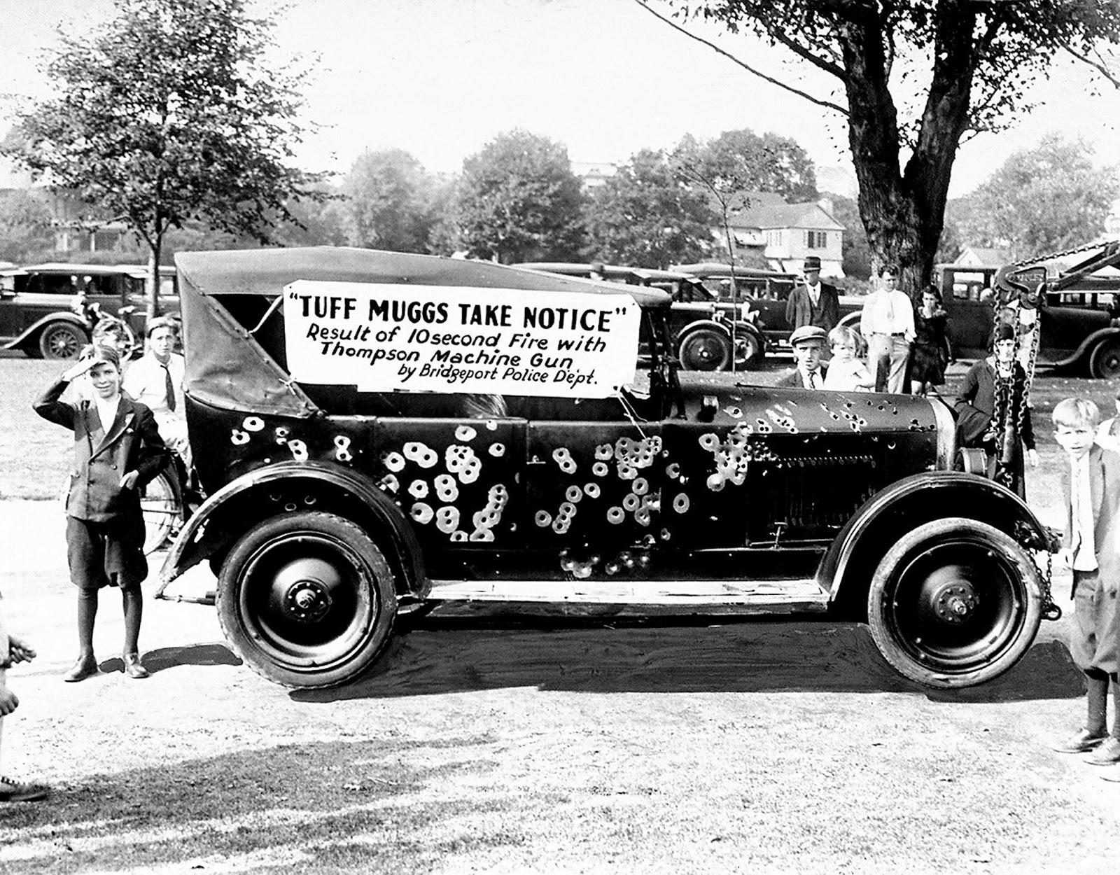 Police display of a gangster's car riddled by Thompson machine guns for