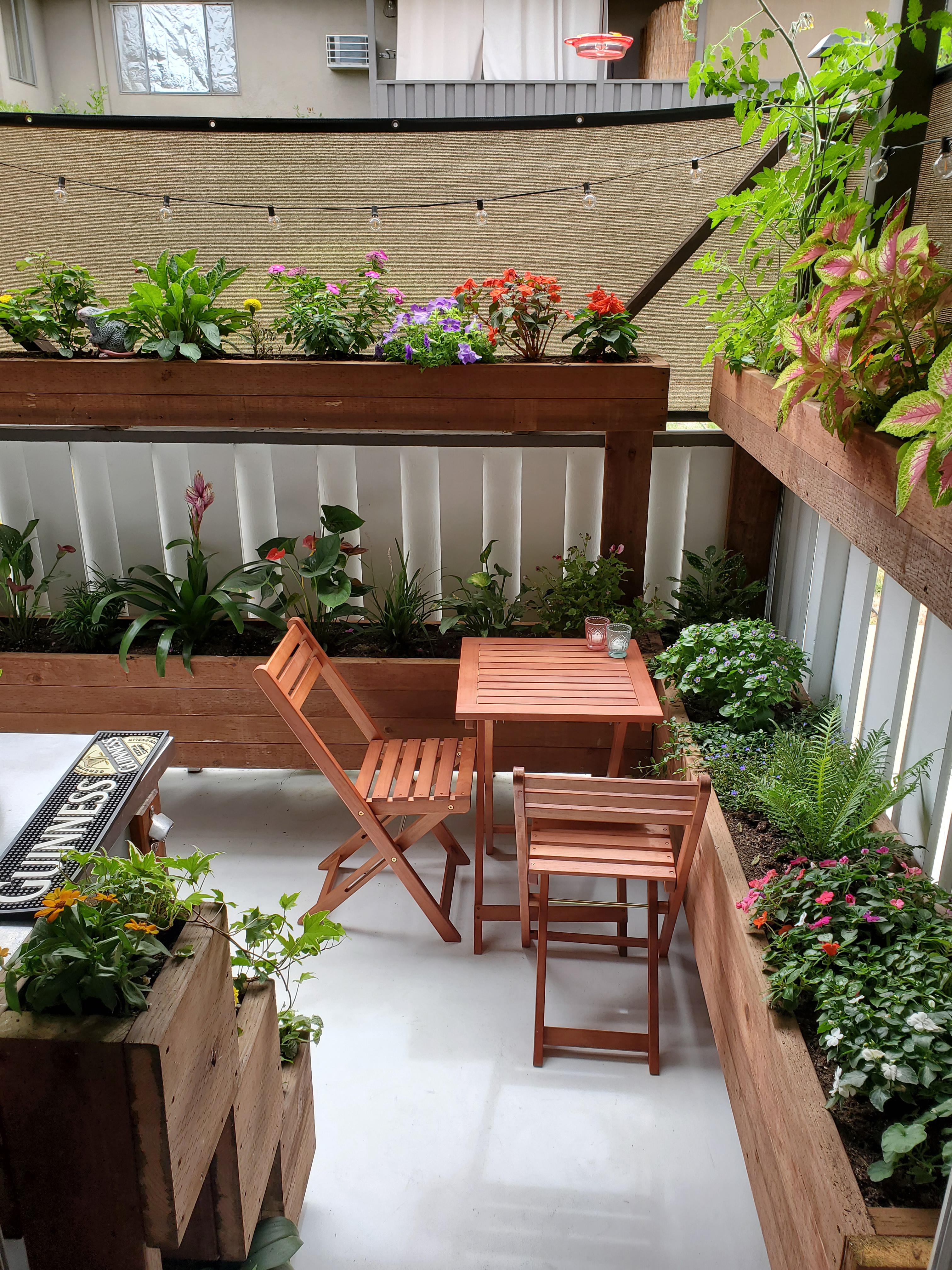 Turned our small apartment patio into a beer/flower garden! r/gardening