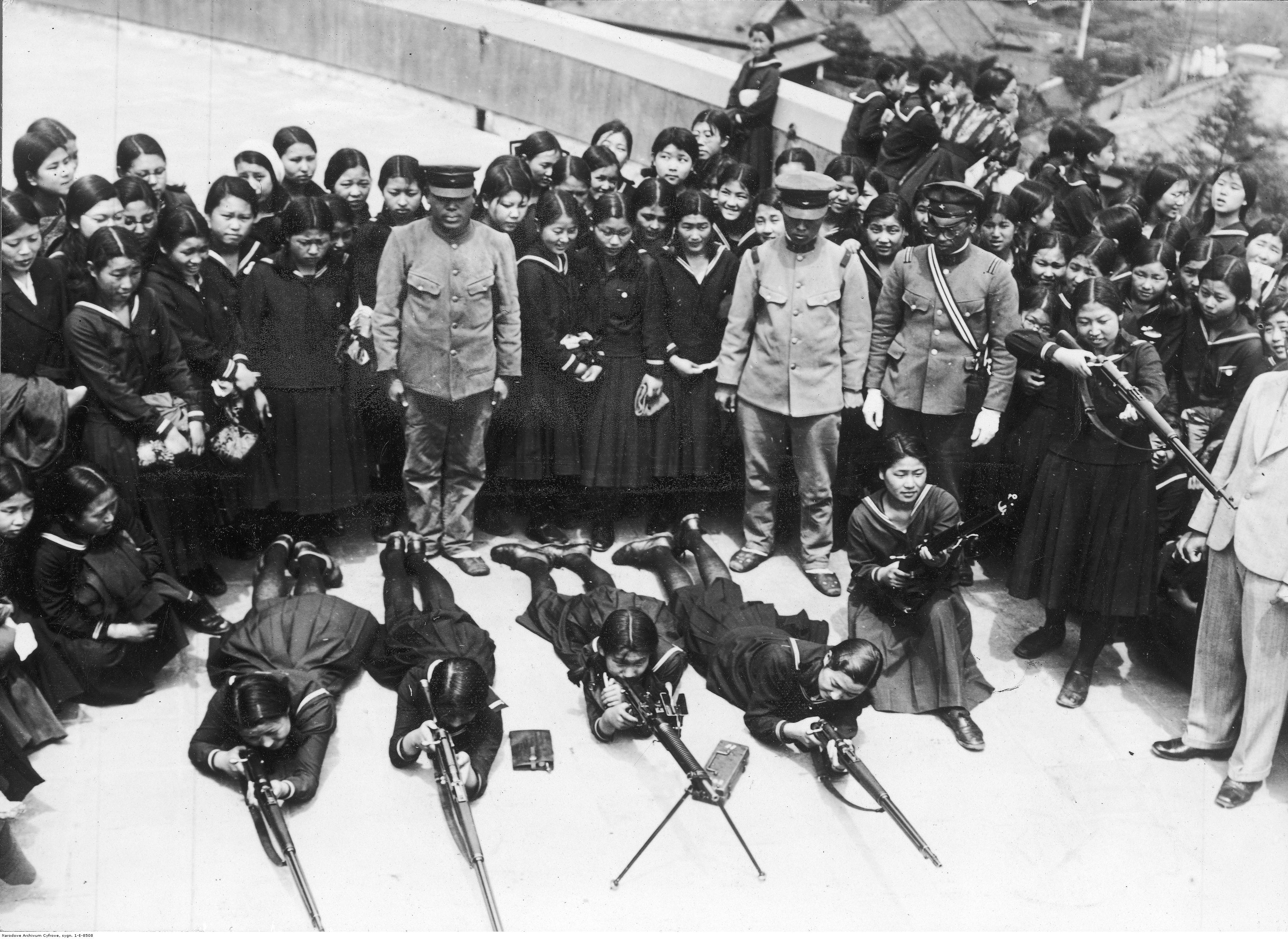Japanese schoolgirls receiving instruction on firearms handling, as