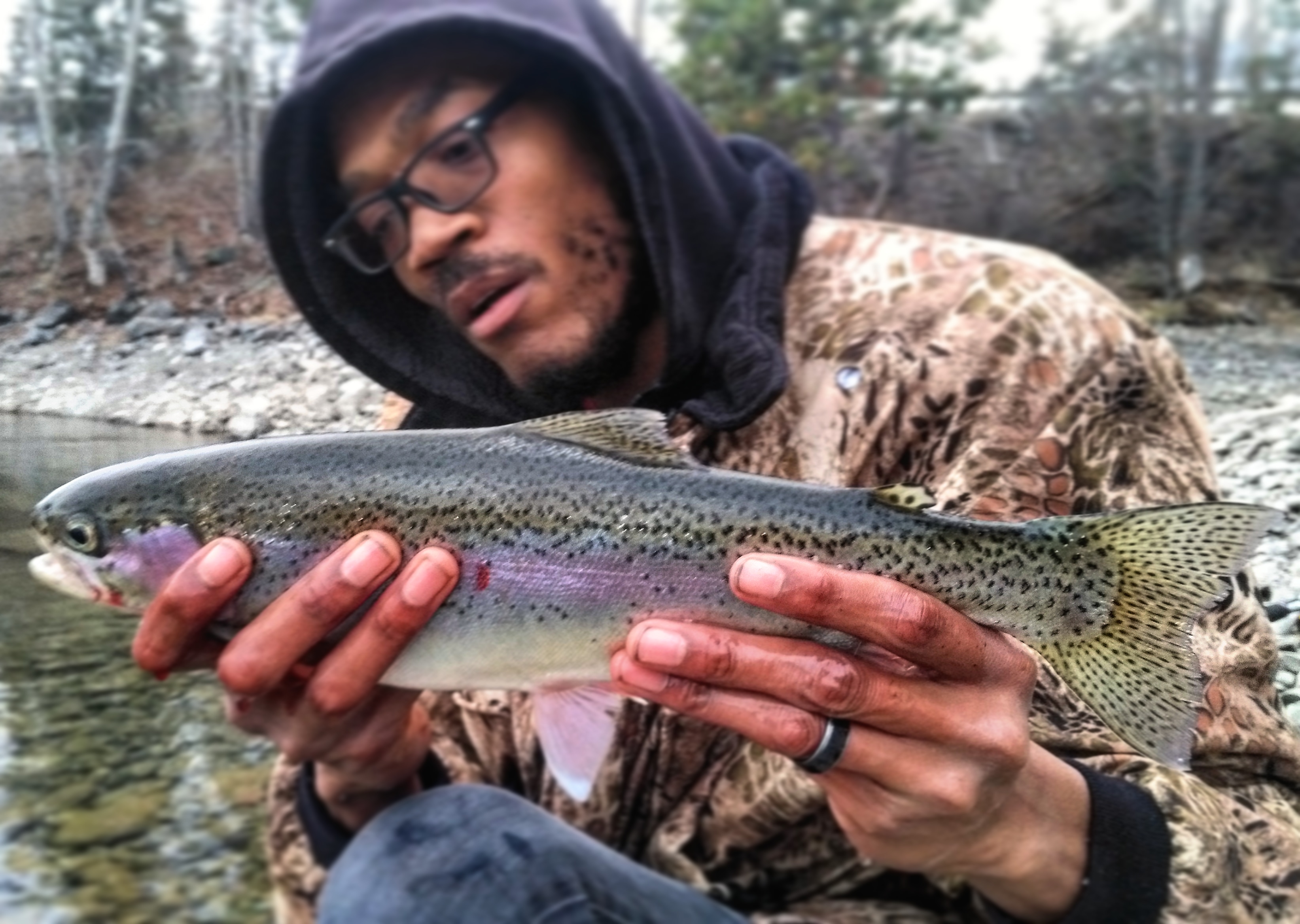 My good buddy putting the hammer down on a beautiful rainbow. r/Fishing