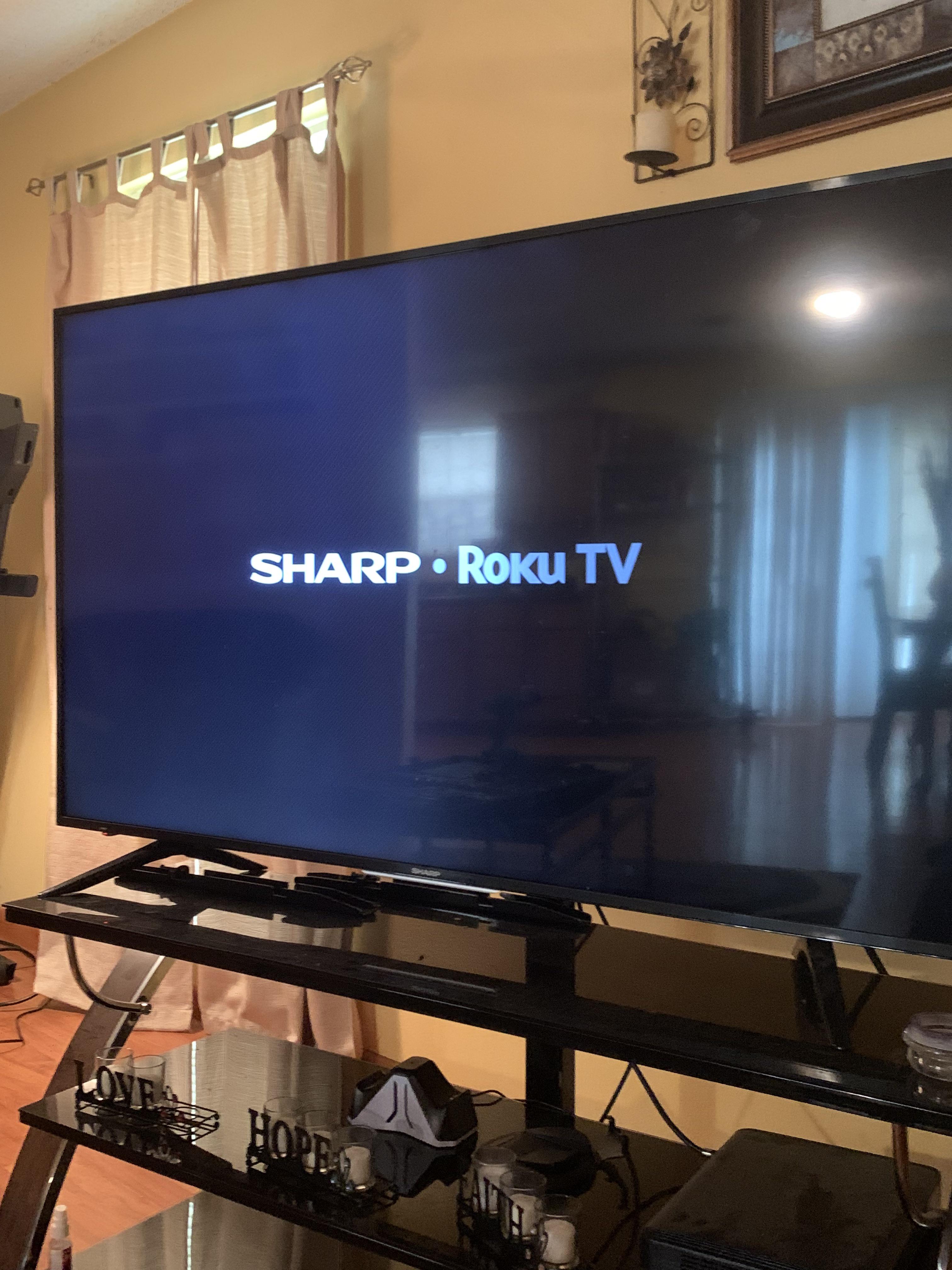 65 Sharp Roku TV in reboot loop. It briefly shows the start screen and
