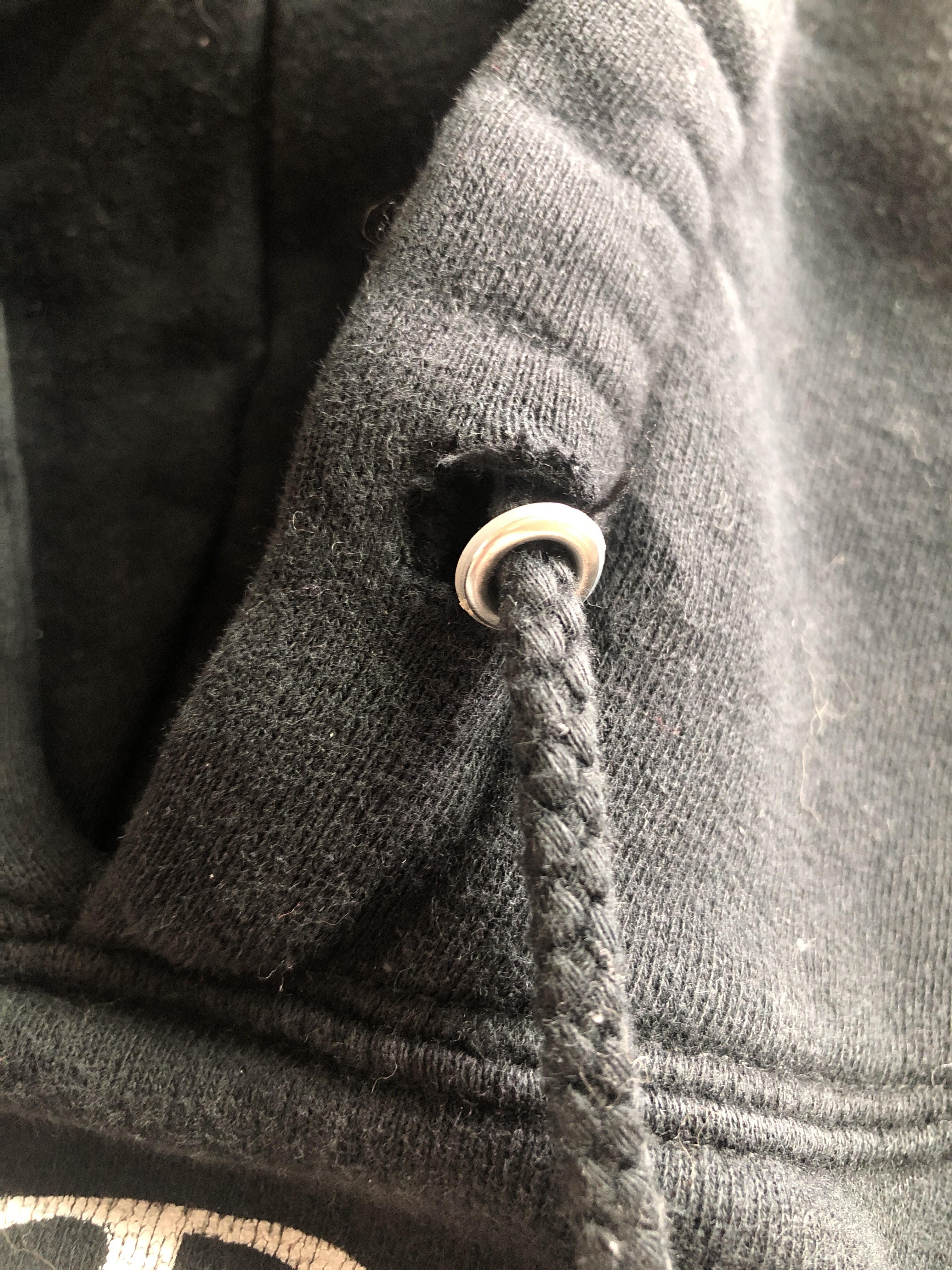 Does anyone know how I could fix this torn sweatshirt grommet? TYIA