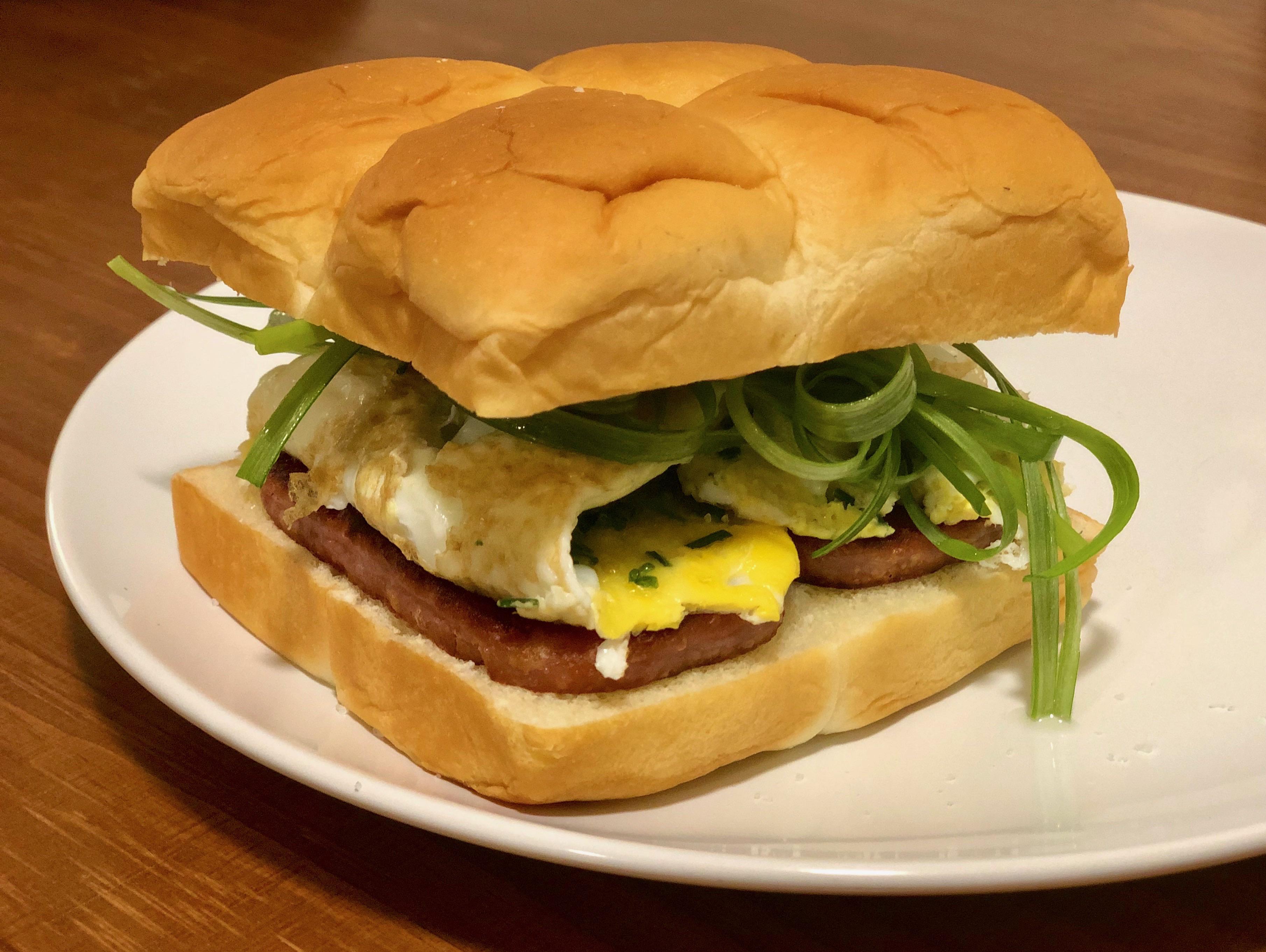 Fried spam, eggs, scallion and sriracha mayo on a Hawaiian roll