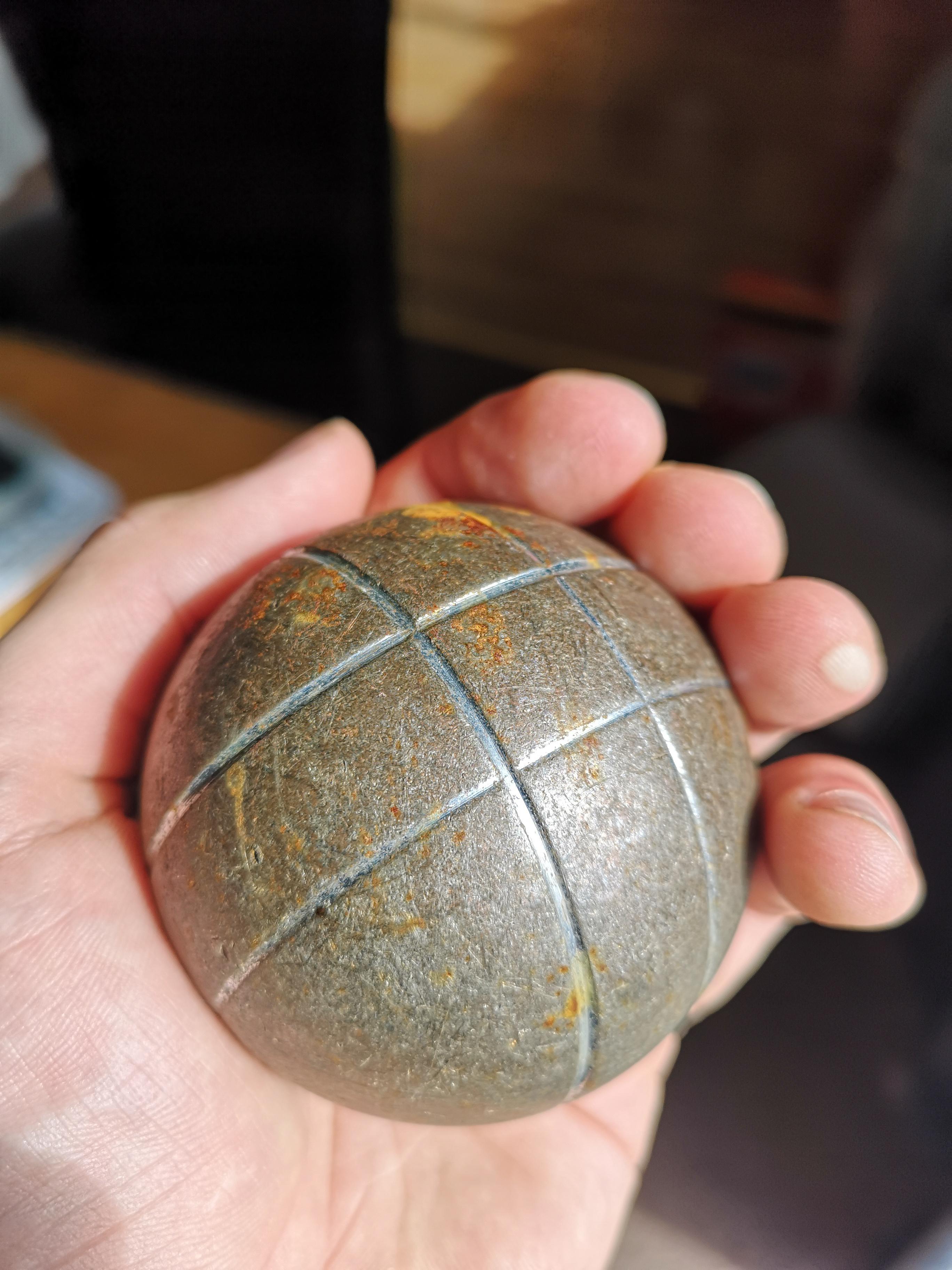 Heavy metal ball with 4 grooves, appeared overnight in a friend's