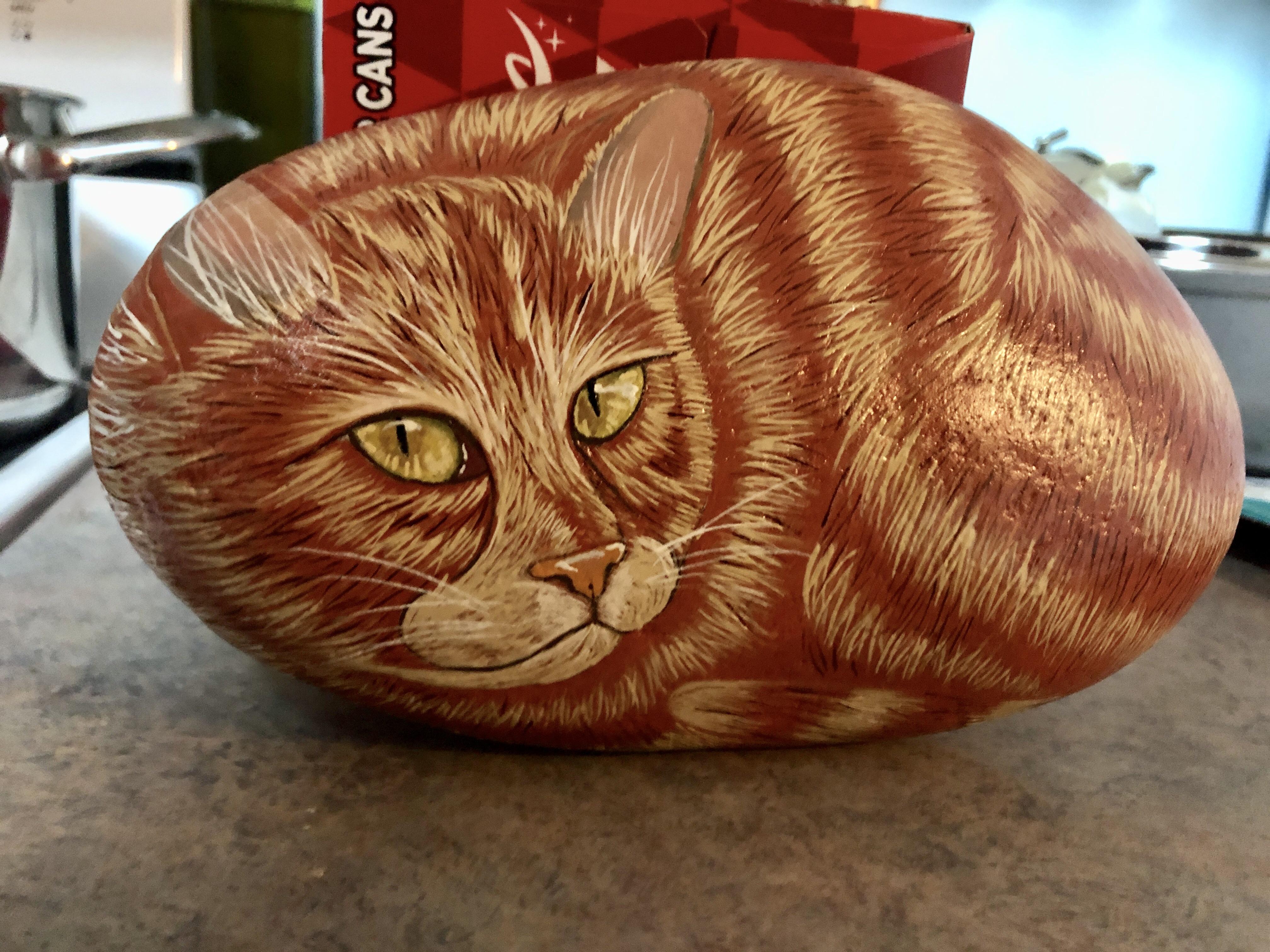 I was commissioned to paint an orange tabby cat on a rock for someone’s