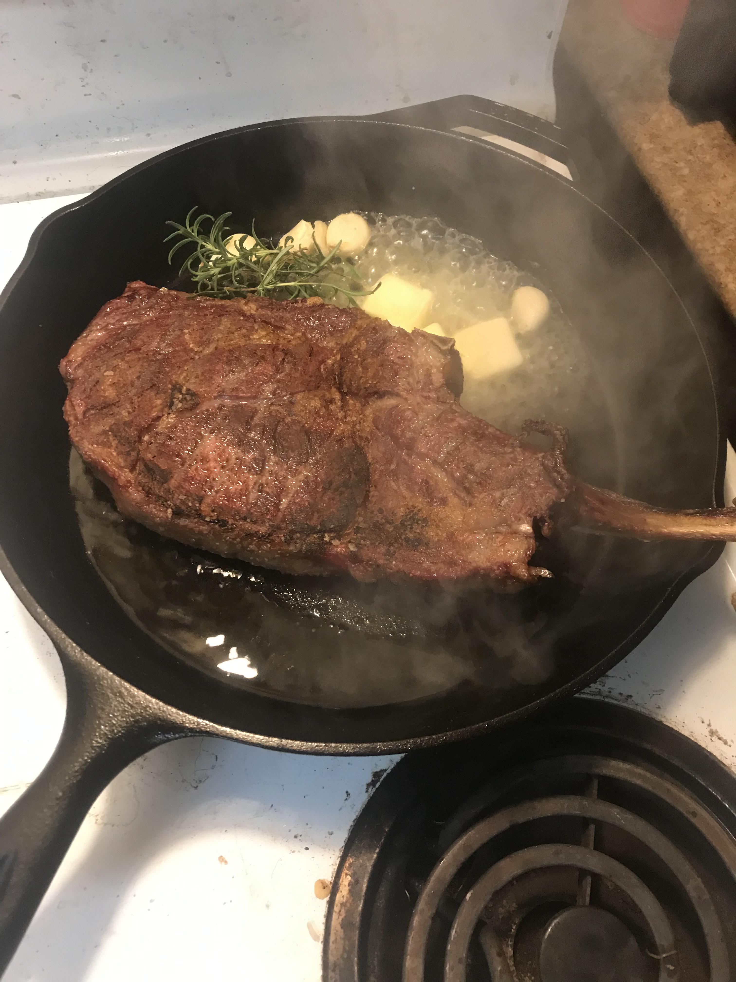 Bone in Ribeye reverse seared on the Traeger then cast iron with garlic